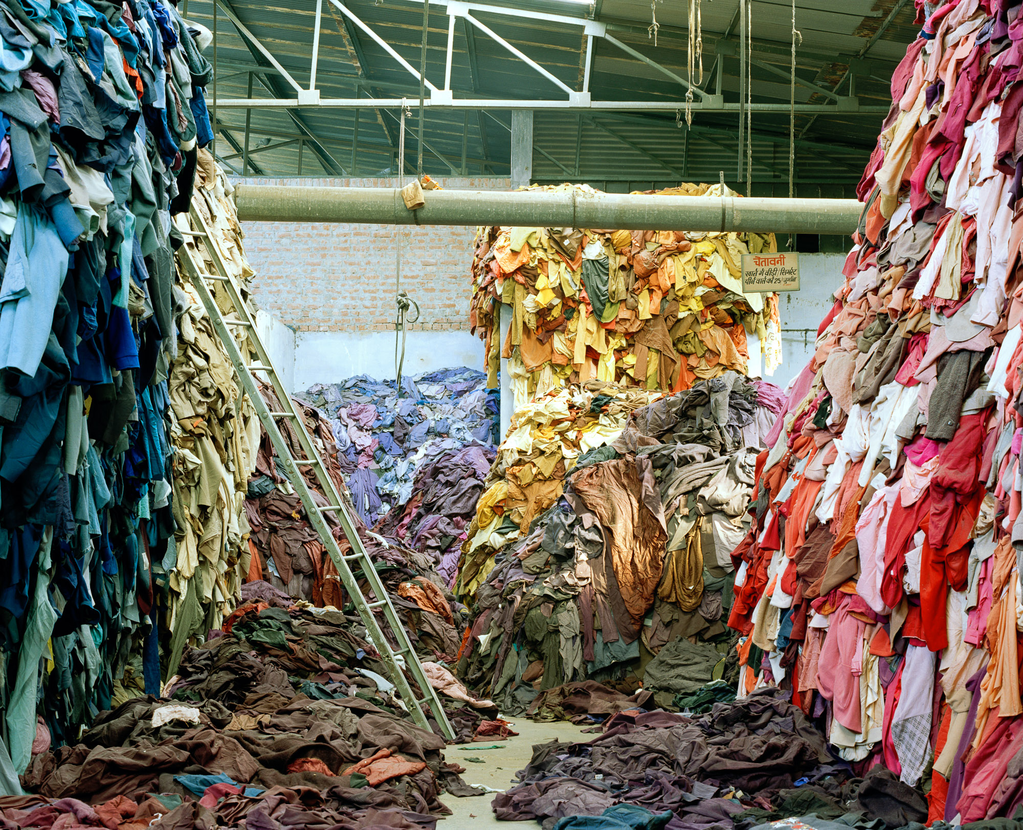 Cast-off woolen clothing is sorted again in large warehouses in Panipat, now into basic colour groups, where it's new value lies.