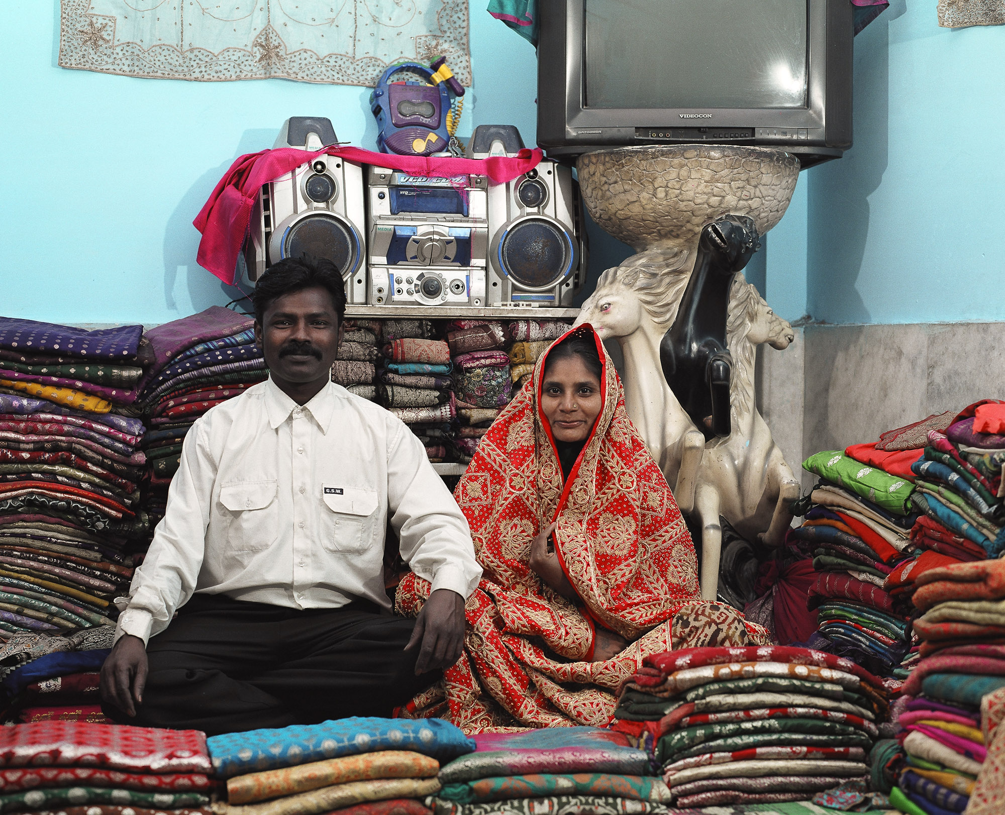  The higher quality clothing will be sold further afield. This Waghri couple deal in silk saris in their home. Such traders amass hundreds of silk saris cast out from wedding trousseau into the secondhand markets for re-sale. 