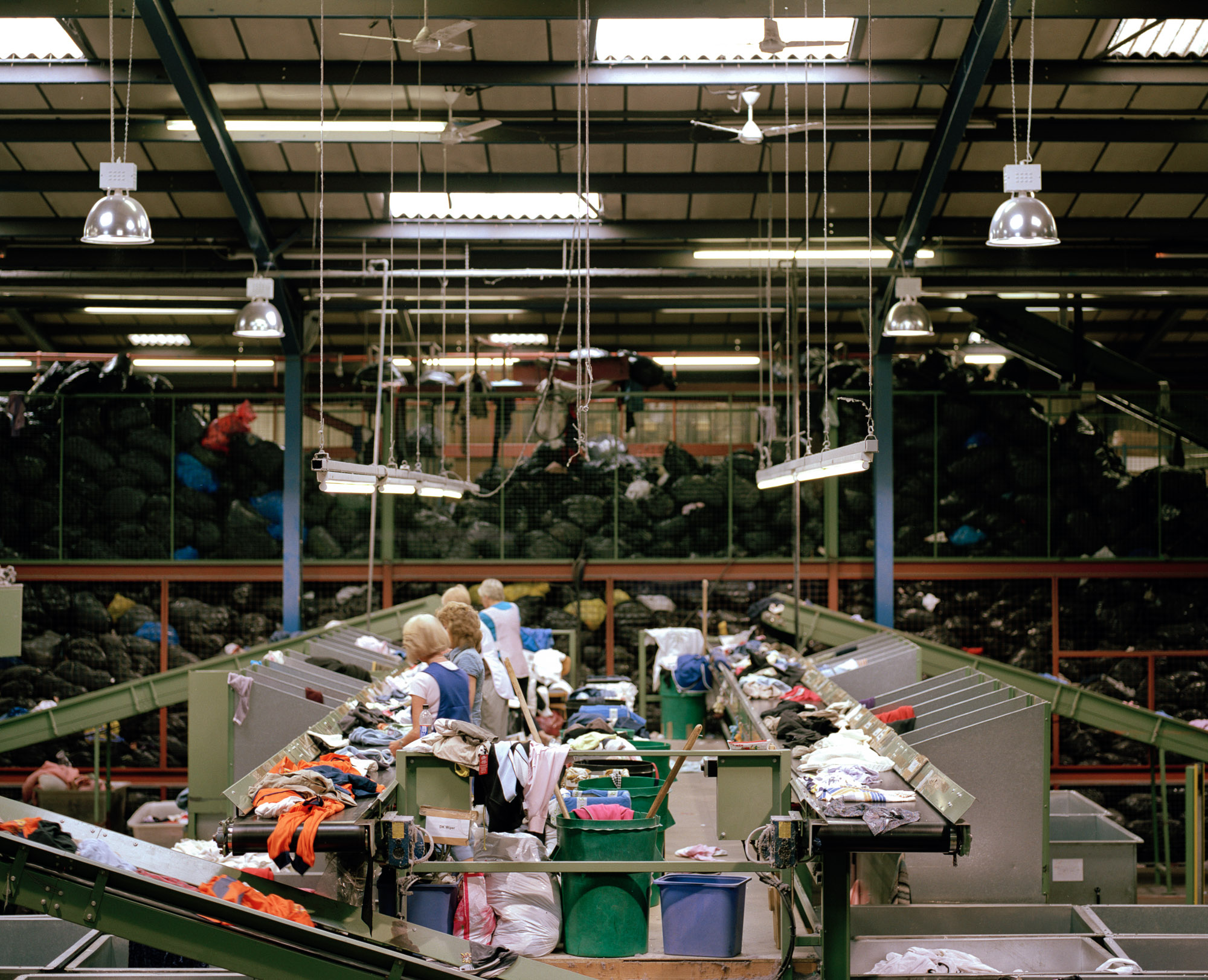 Meanwhile, a textiles recycling depot in Yorkshire collects clothing donated from all over the country. Mountains of black plastic bags are split open and their contents sorted on conveyor belts.
