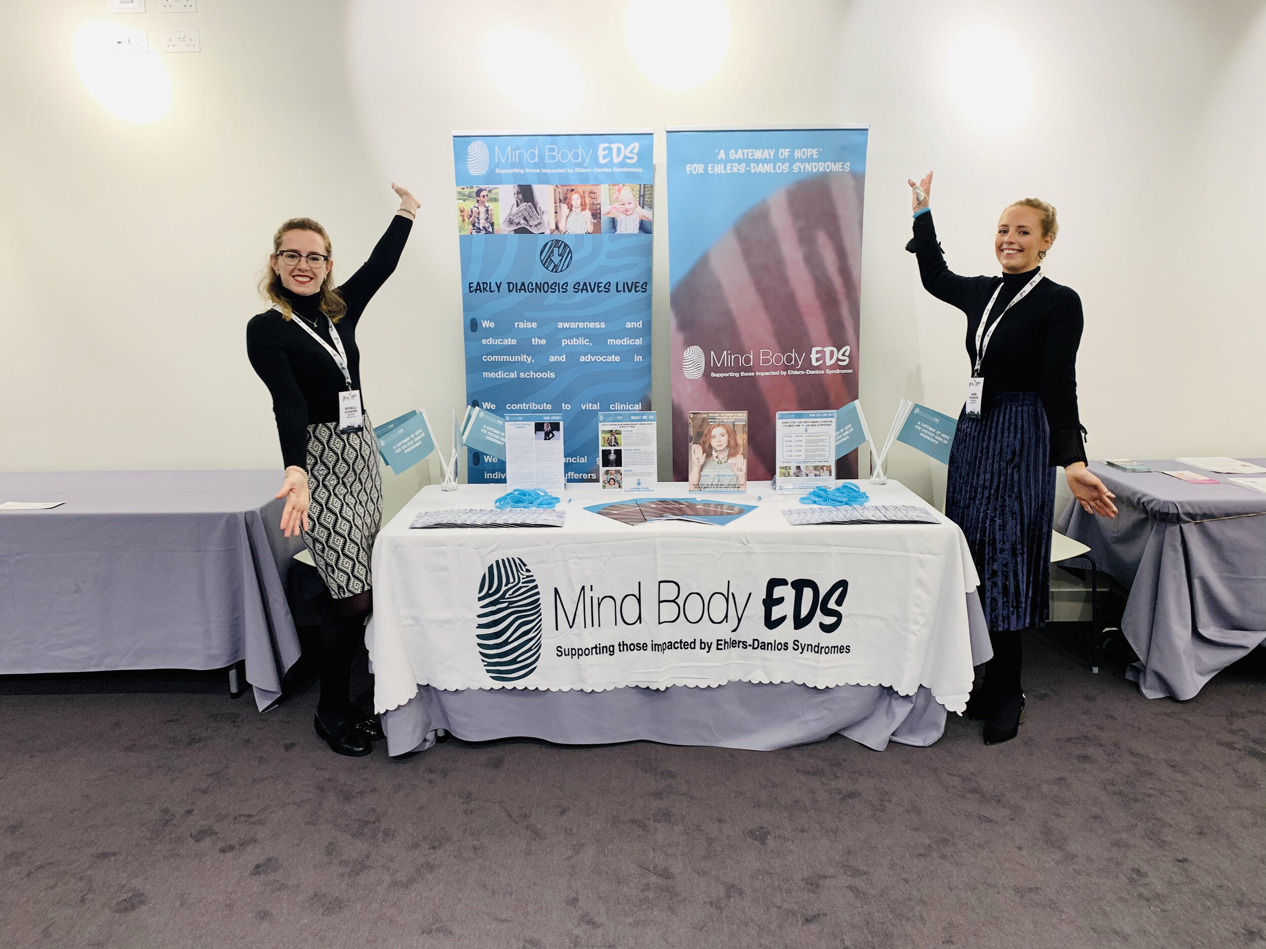 Rochelle (Volunteer) and Laura Sylvester (Founder) with Mind Body EDS conference stand