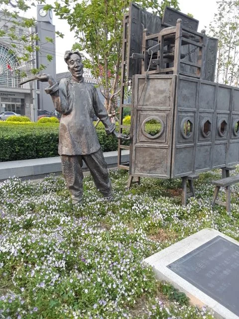 During our search or food, we passed an arts complex that included several statues of famous cultural figures from China's past. This one may have been a comedian.