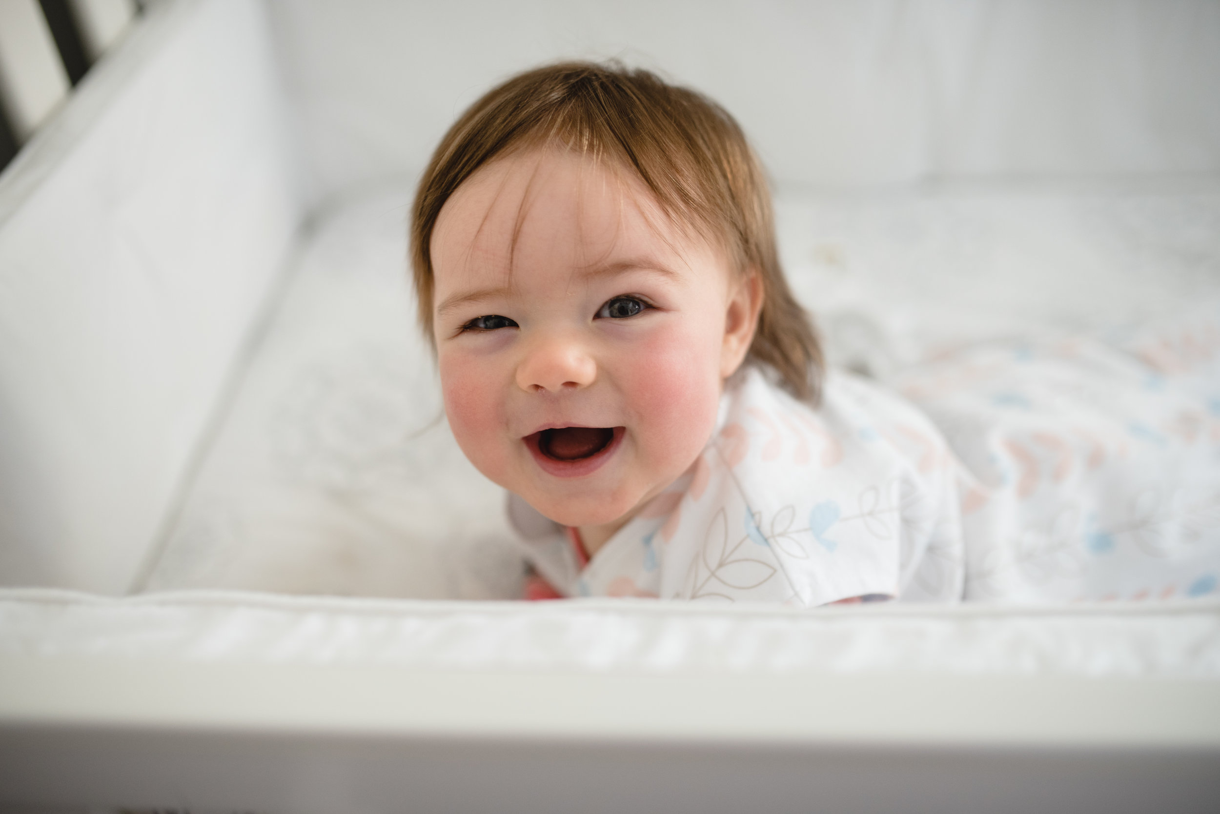 baby laughing in crib