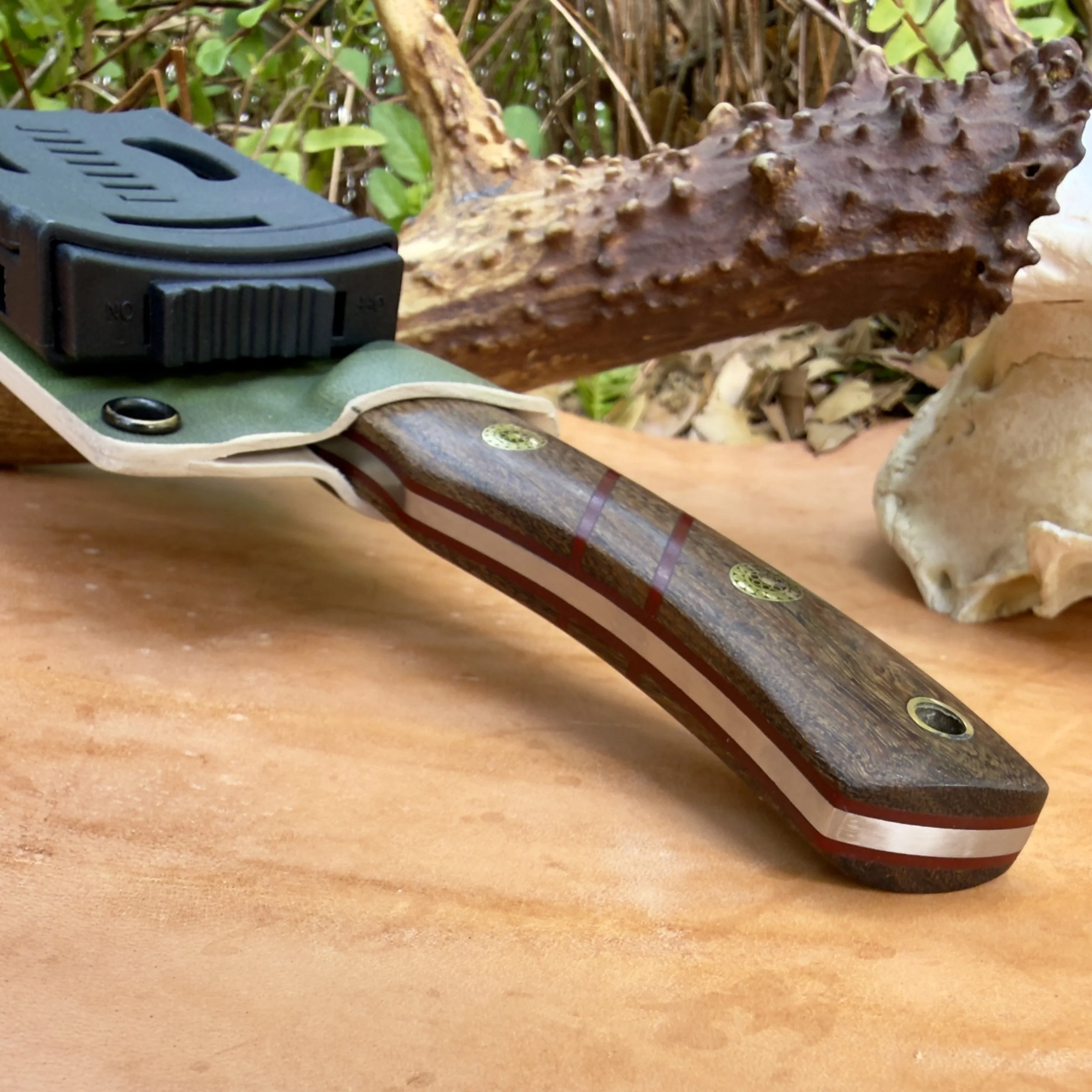 Side profile of handmade coffeewood skinner knife showing handle shape and grain