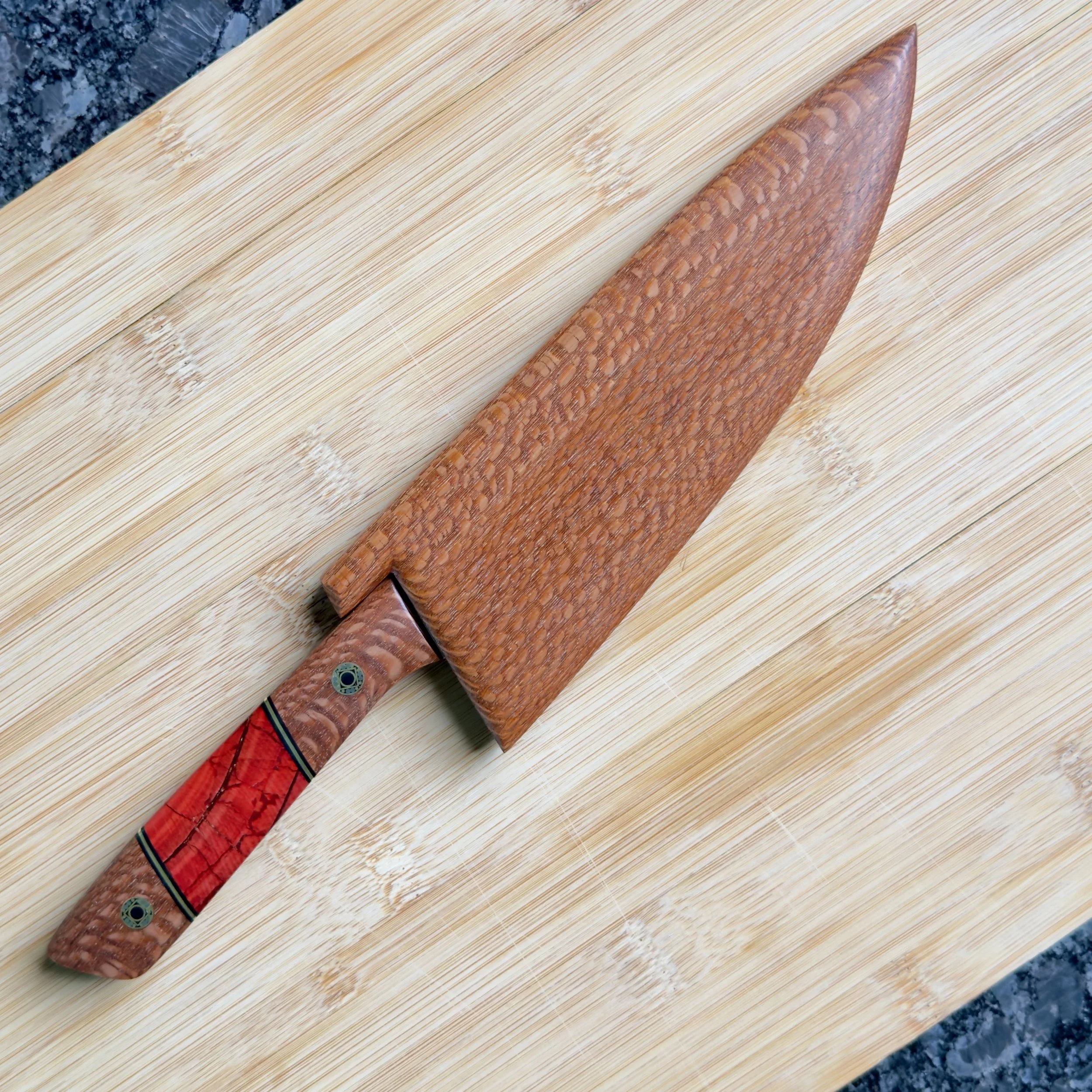 Lacewood chef knife partially sheathed in magnetic wooden saya on cutting board