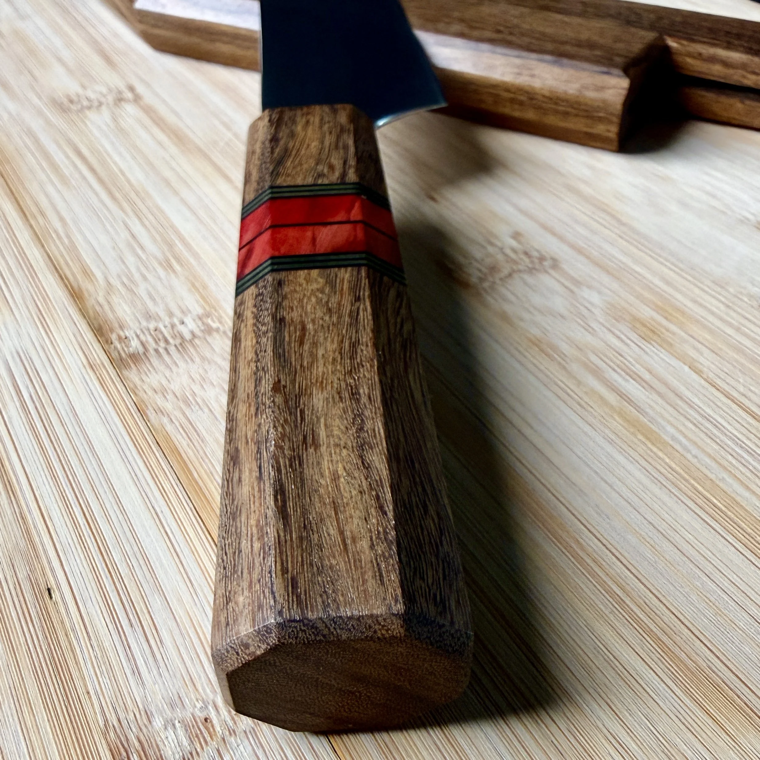 Close-up of coffeewood handle end grain with mammoth tusk accent
