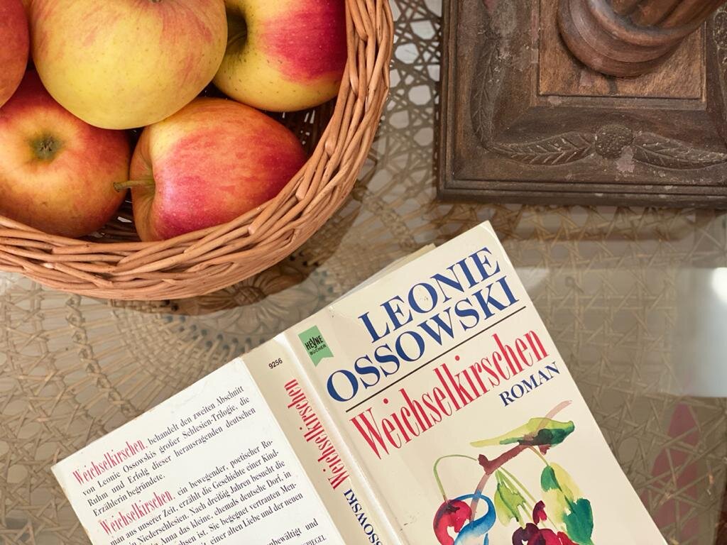 a locally made fruit basket, and the novel weichselkirchen sit on the night table