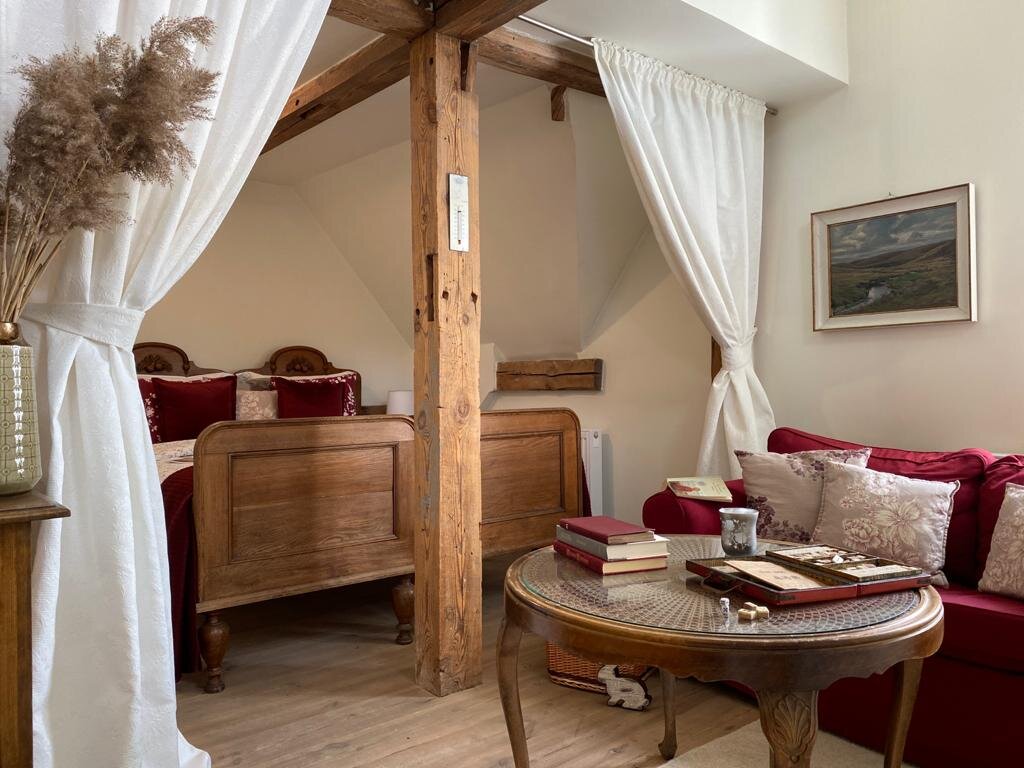 the curtained bed chamber with velvet pillows and throws