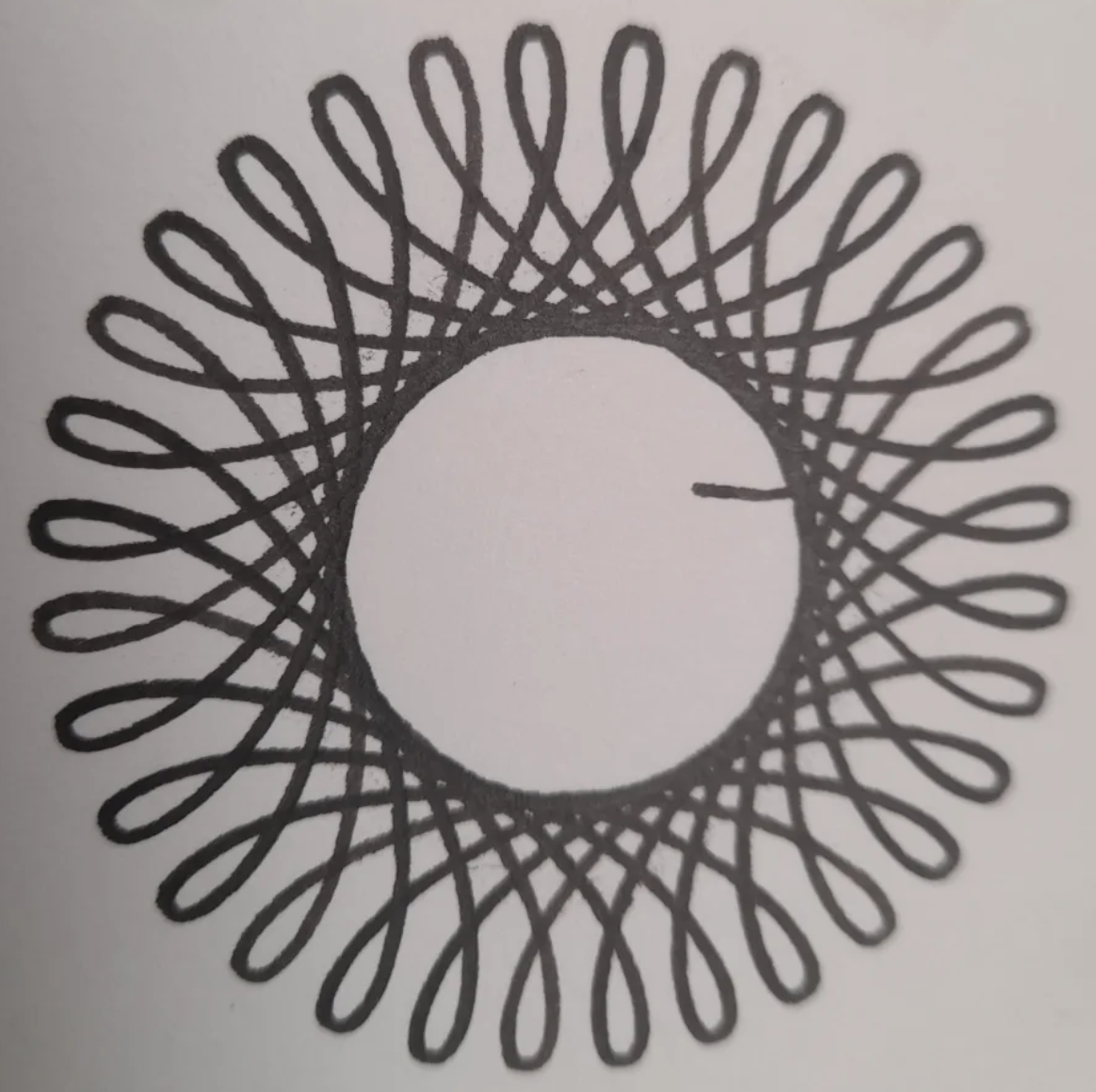 A spirograph pattern drawn in black ink
