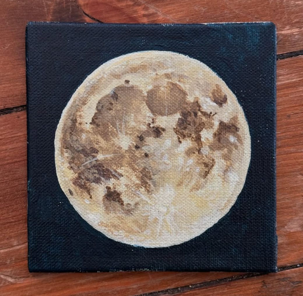 A small square canvas with a painting of the full moon.