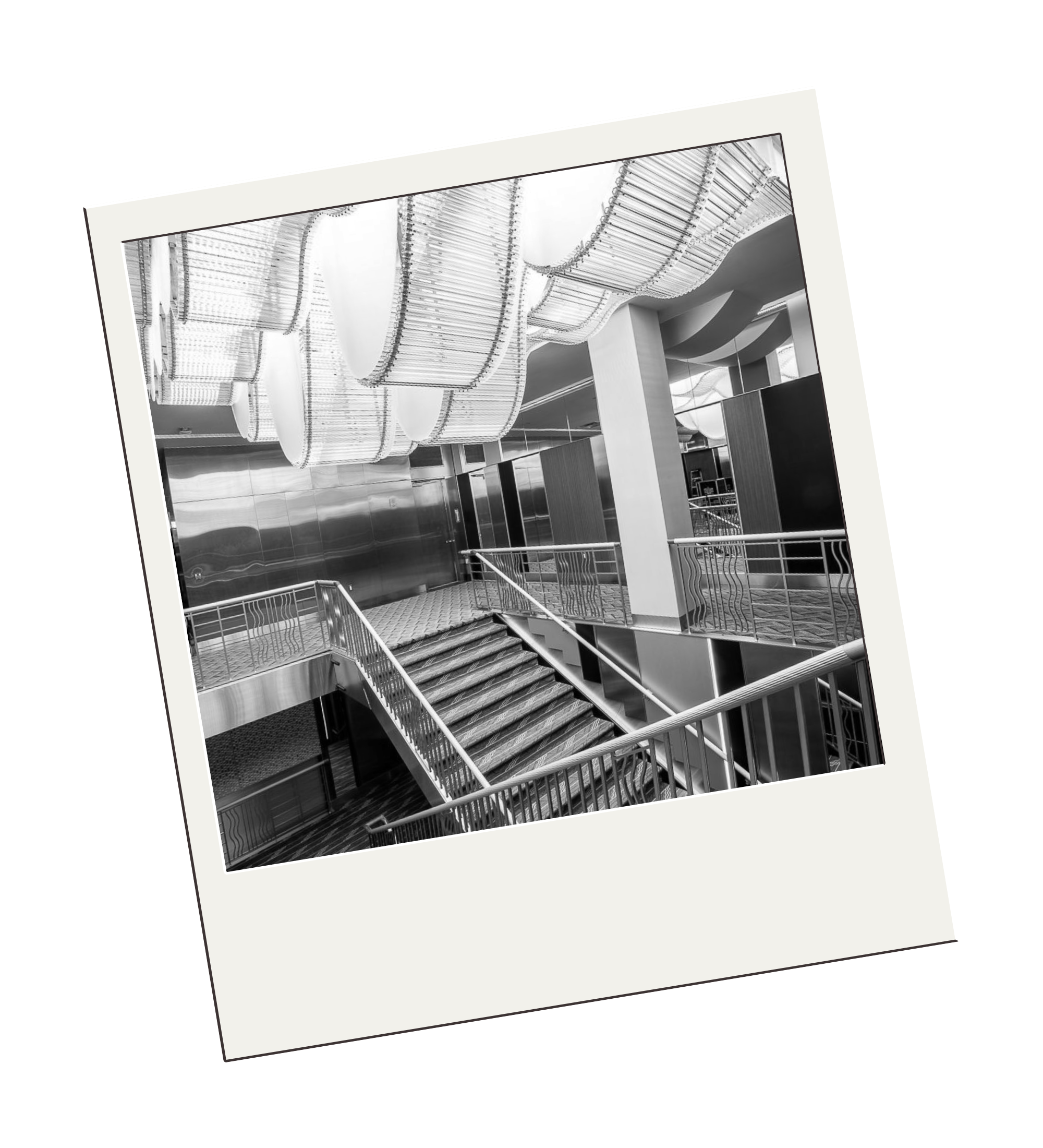 Black-and-white photograph of the Ziegfeld Ballroom interior featuring a grand staircase and modern lighting