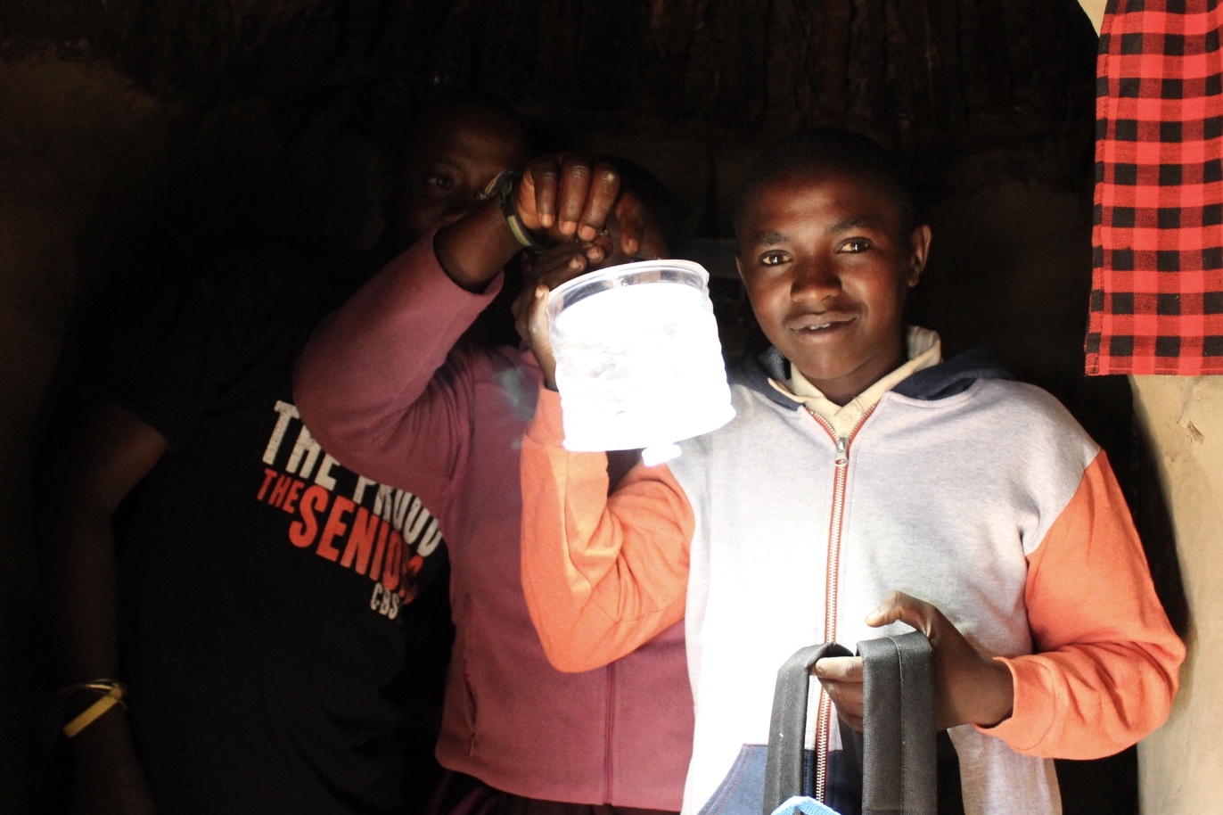 Maasai Boy with solar light (Copy)