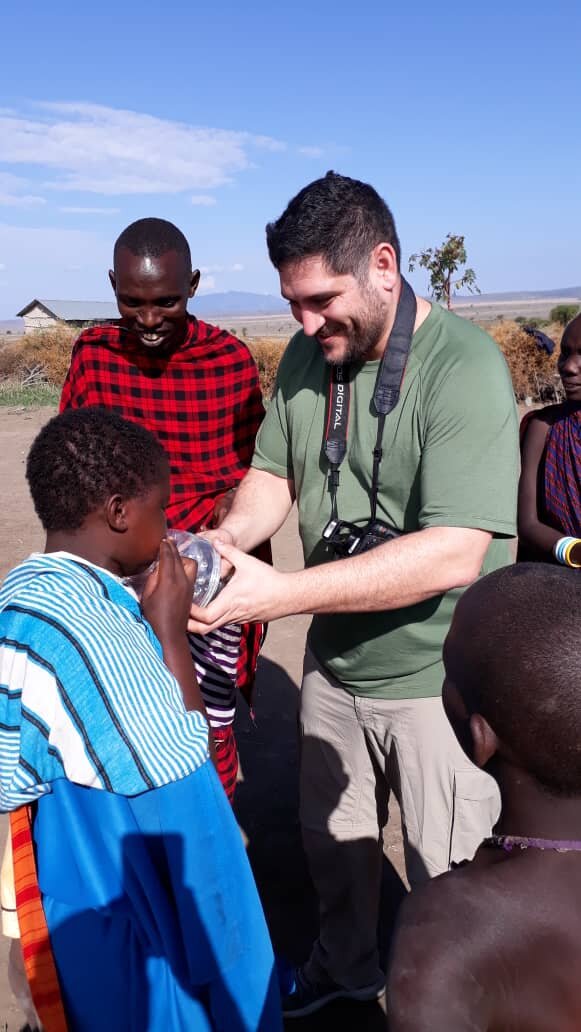 Sababu Safaris guest distributing solar light to Maasai