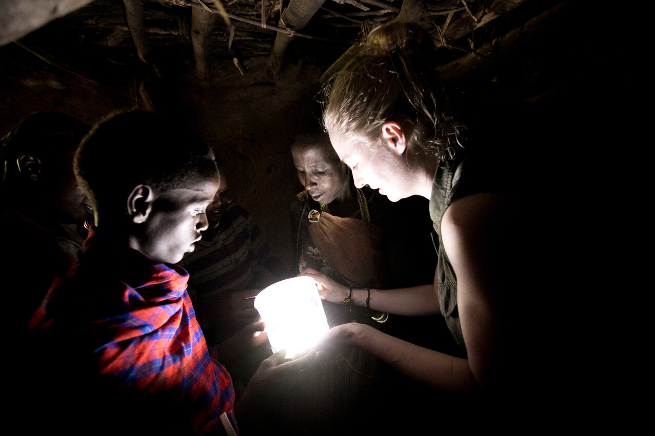 Maasai with solar light in boma