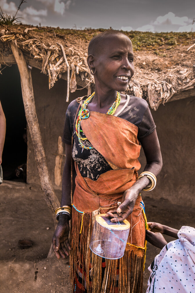 Datoga woman showing her new solar light