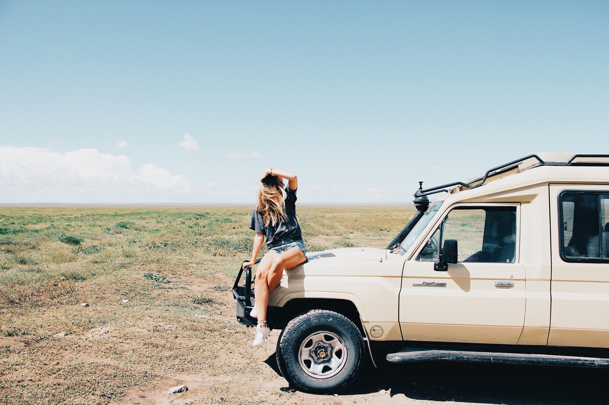 Girl on safari vehicle