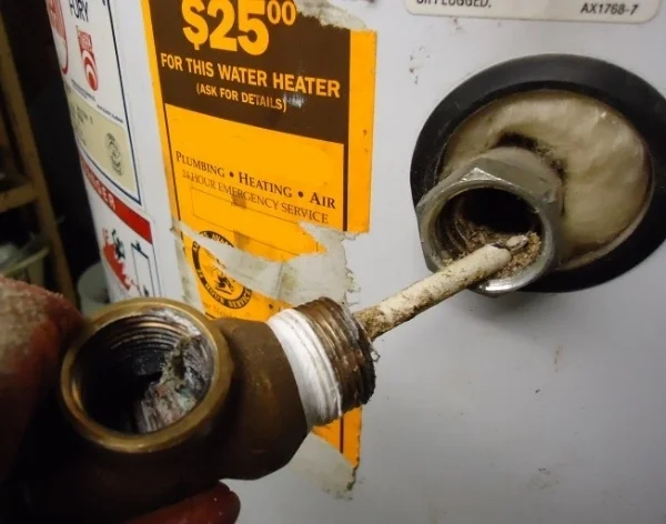 After this water heater had leaked, it was disassembled. it shows how much sediment ends up in and near the drain valve.