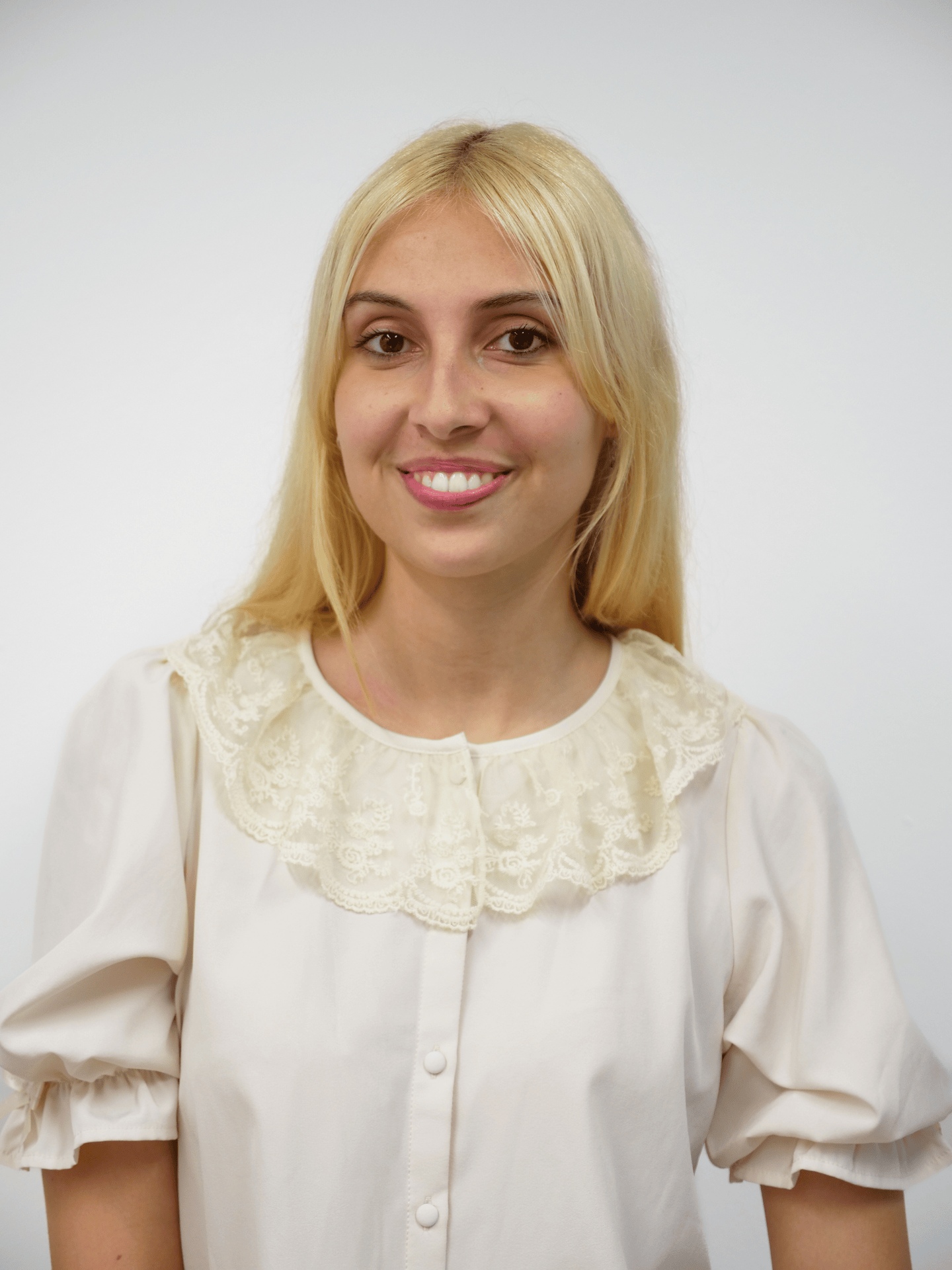 A gif cycling through several portraits of a figure. The figure has long blonde hair. They are wearing a white top with a lace collar and poofy short sleeves.