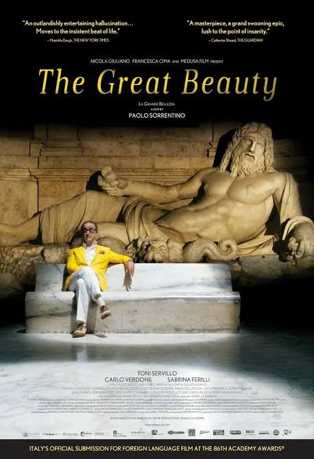 La Grande Bellezza (The Great Beauty), Paolo Sorrentino (2013). film poster. man in yellow suit sitting in front of a male sculpture.
