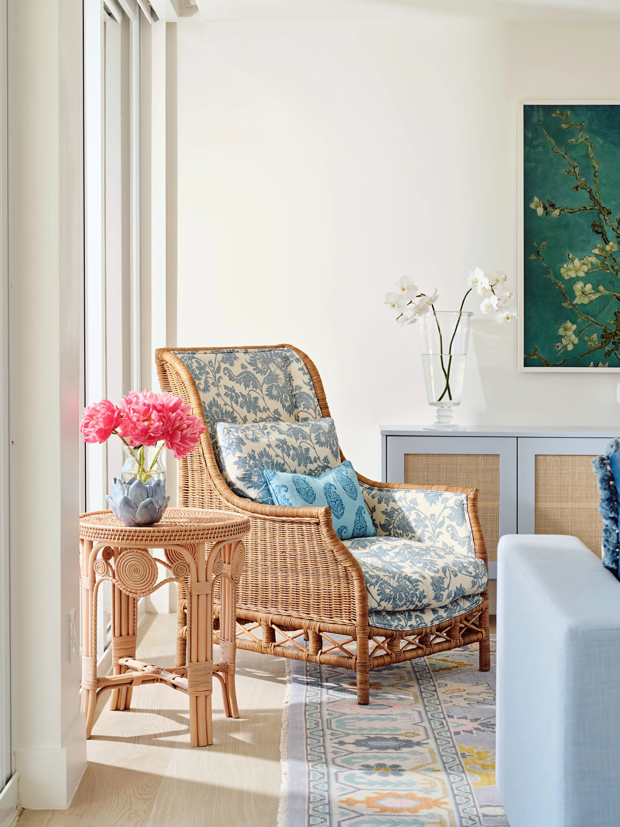 palm-beach-condo-renovation-whitney-ross-living-room-rattan-chair-coastal-transitional-flowers.jpg