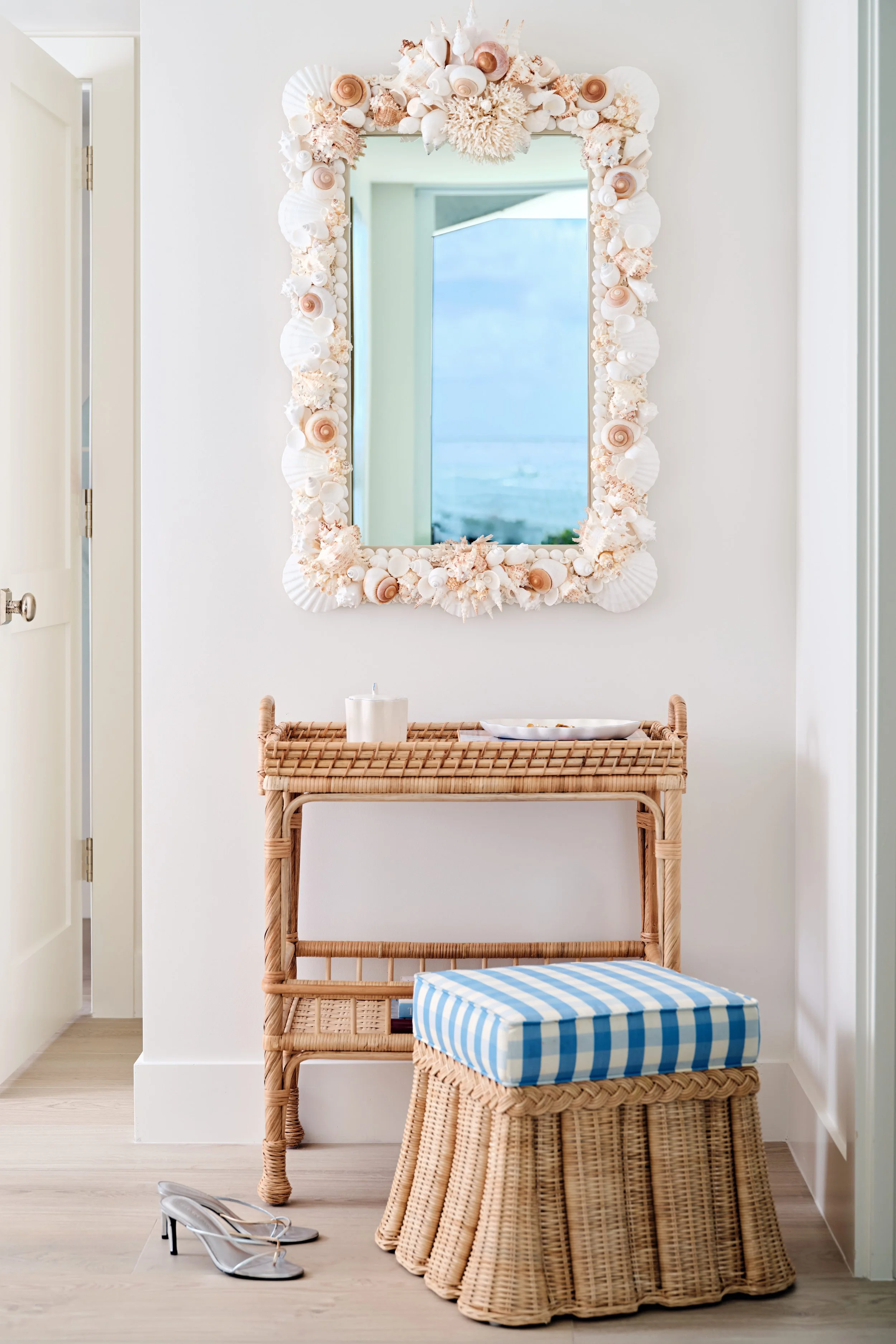 palm-beach-condo-renovation-whitney-ross-vanity-rattan-stool-desk-shell-mirror.jpg
