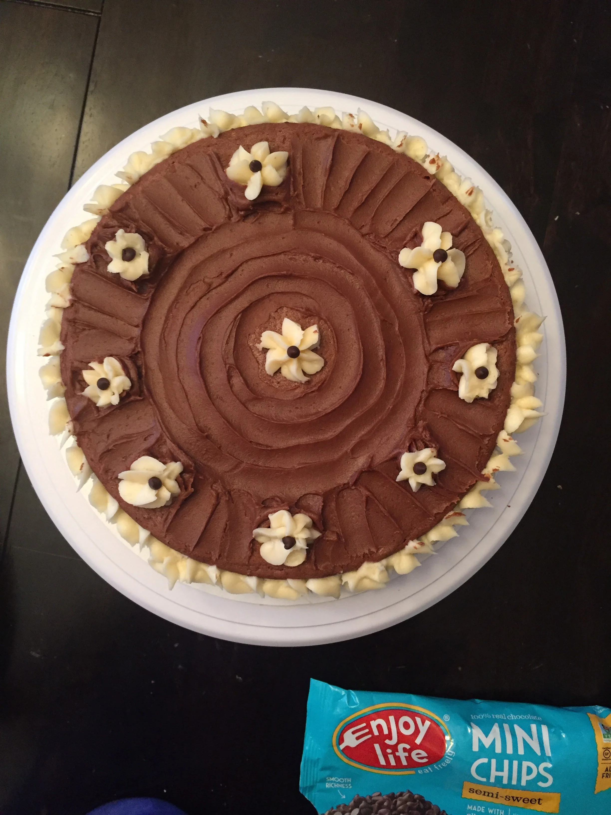   Chocolate Cake w/ dual chocolate and vanilla buttercream .  Sandwiched between this dual layer cake is a vanilla buttercream frosting with Enjoy Life mini chocolate chips.&nbsp; Vanilla buttercream flanked the sides and chocolate buttercream was us