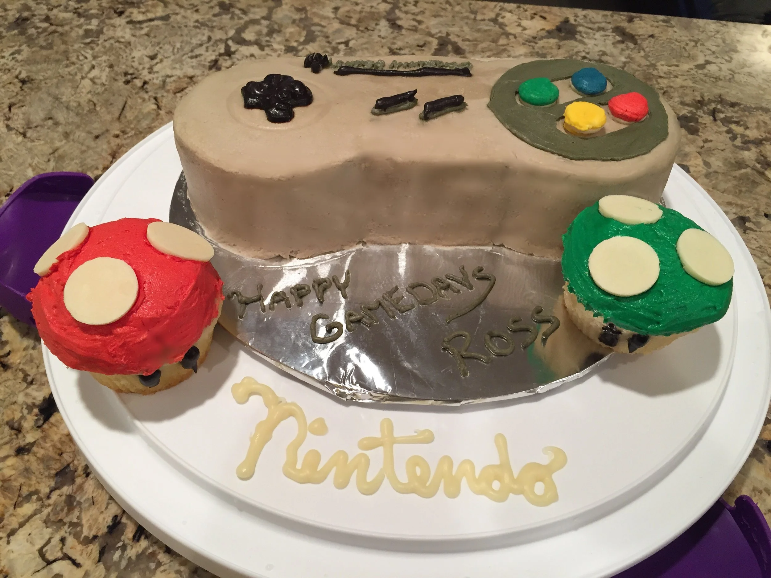   Gluten-free Vanilla Character Cake :  This Super Nintendo controller cake with Super Mario Bros. mushroom cupcakes was made for a friend going to the gaming conference.&nbsp; It is made out of a gluten-free vanilla cake with vanilla buttercream fro