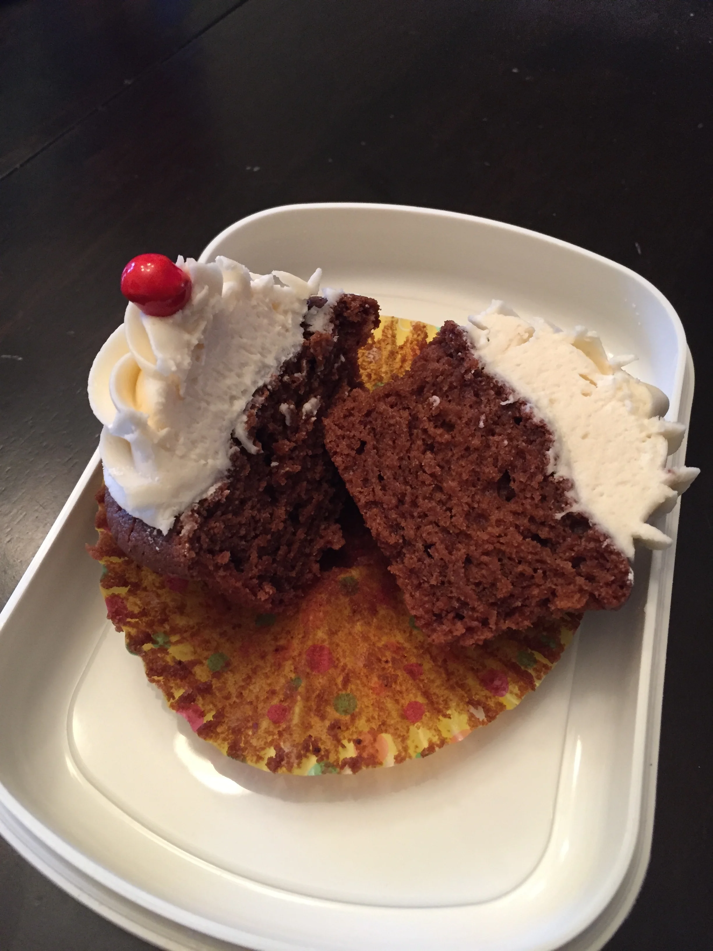   Sweet Perfection:   This is the chocolate cupcake with vanilla buttercream cut open to show the perfect consistency...yum.&nbsp; Even with a cherry looking sixlet on top! 