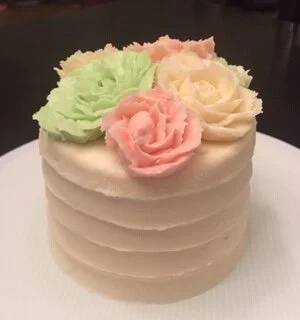 This ripple sided smash cake has buttercream roses on top. 3 or more roses is a $5 charge.