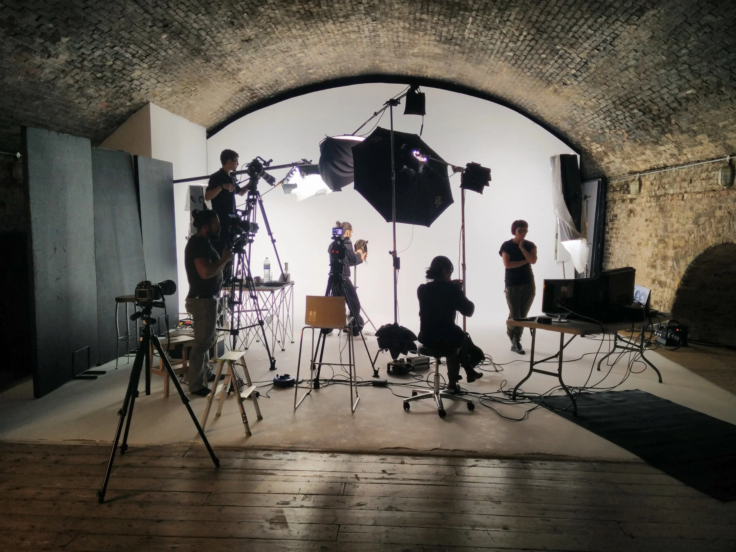 Behind the scenes with the filming crew filming a hair styling educational videos.