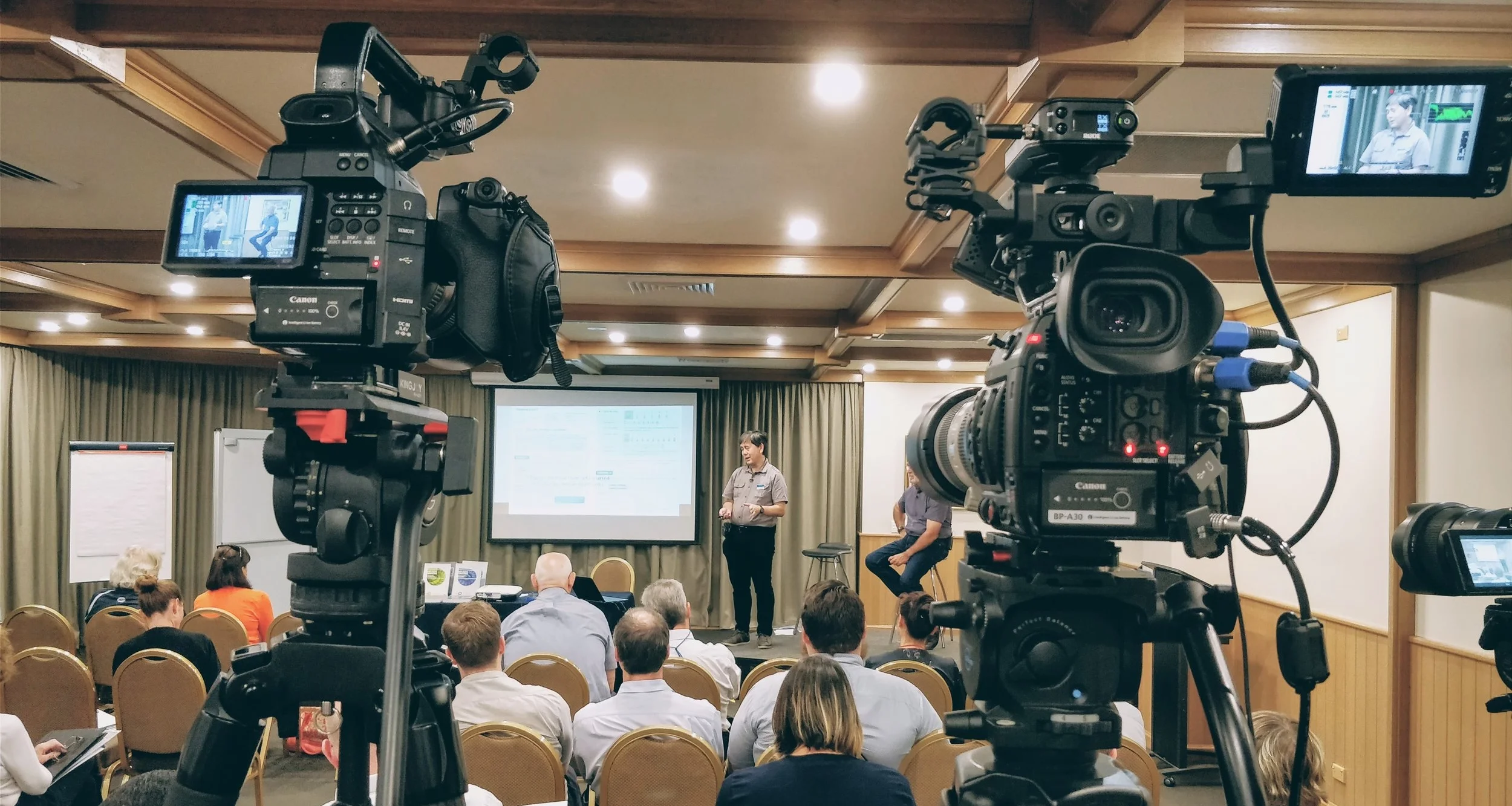 Behind the scenes of filming a conference.