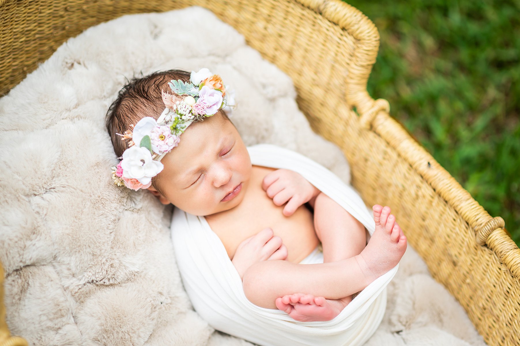  Infant baby with flower crown and wrapped in cheese cloth 
