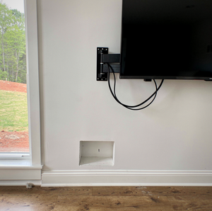 Low profile tv bracket with recessed outlet behind drywall