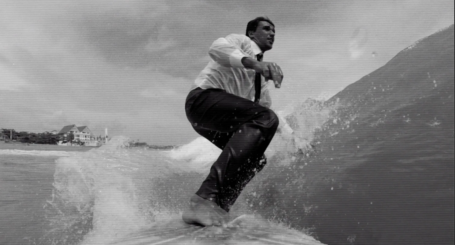 A young businessman surf the wave of corporate investment.