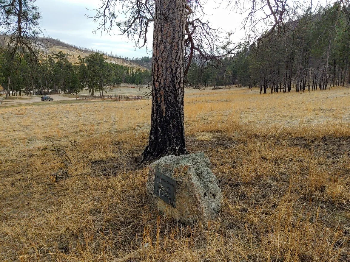 The corrals are south of the gravesite and to the east.