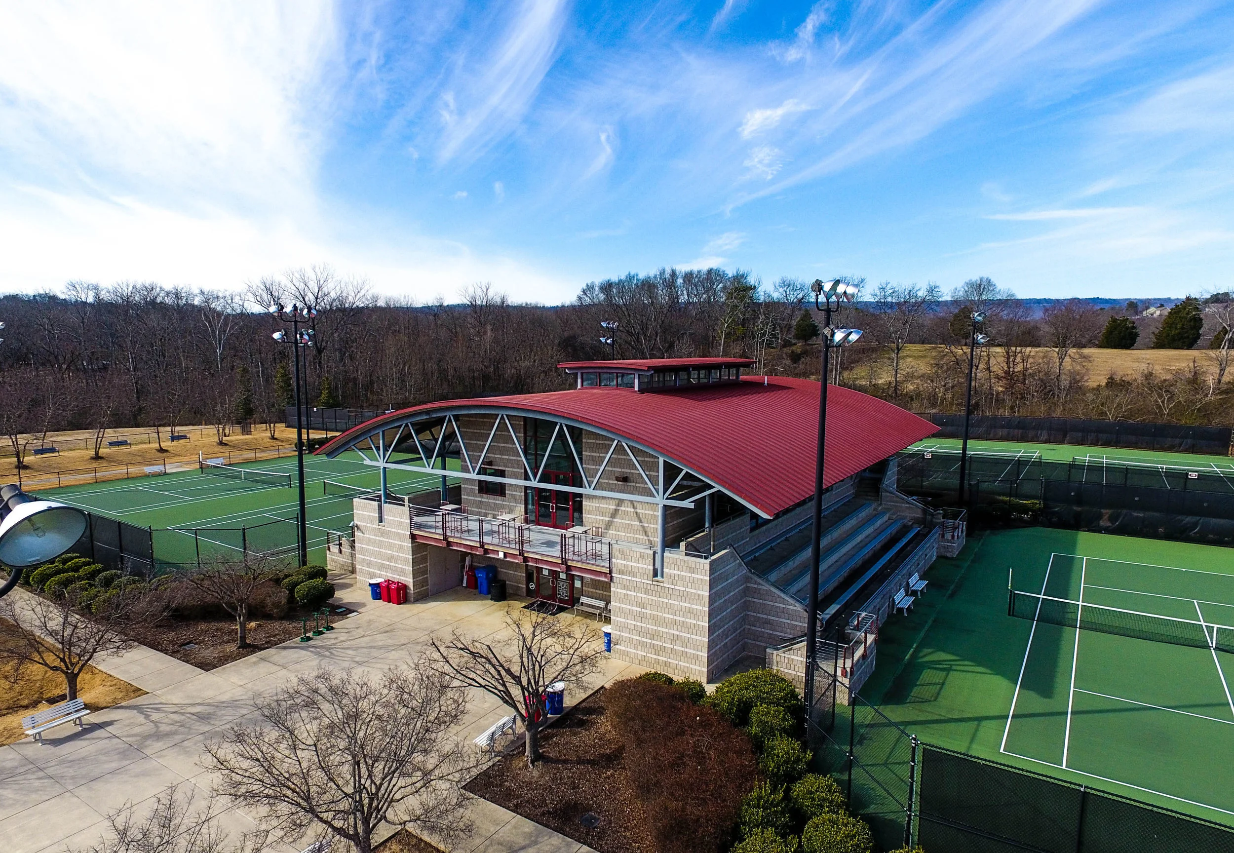 The Champions Club The Champions Club is a high quality, public access tennis club located near Downtown Chattanooga, TN. Our build for this club features a 6,000 square foot clubhouse with all the amenities: locker rooms, lounge areas, offices, and a full service pro shop. Surrounding the complex are 26 hard courts with bleachers that are used for recreational play as well as national and regional tournaments held throughout the year.