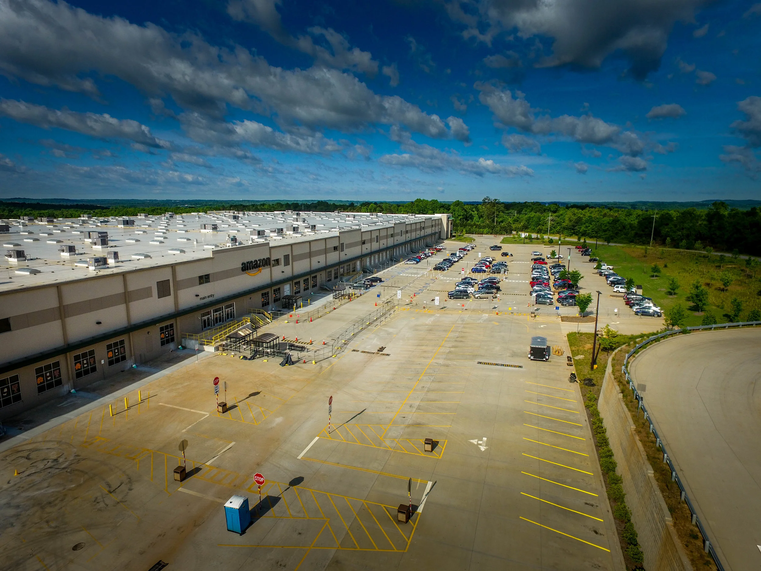 Amazon MGE3 At the Amazon MGE3 Distribution Facility in Adairsville, GA we completed a complete parking lot renovation including new traffic routes, entrance modifications, saftey, and the addition of a new drainage system tying the existing downspouts to an underground storm-water system to eliminate standing water in the parking area.