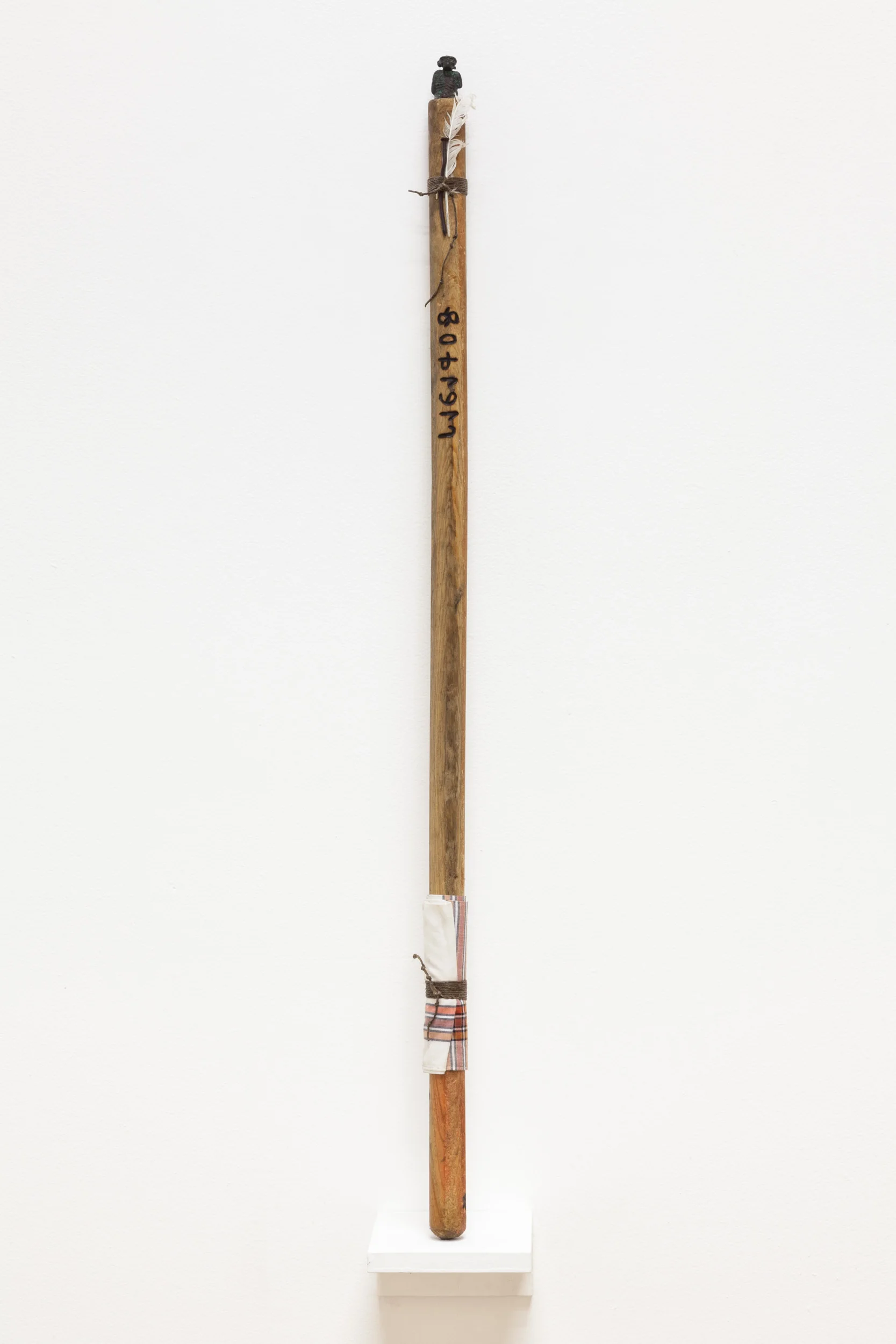 Lazaros Wand , 2016 wood, bronze, hemp twine, feather, tooth, handkerchief, rusty nail, rare earth magnet, consecrated oil 37 x 1 ¾ x 1 ¾ in.