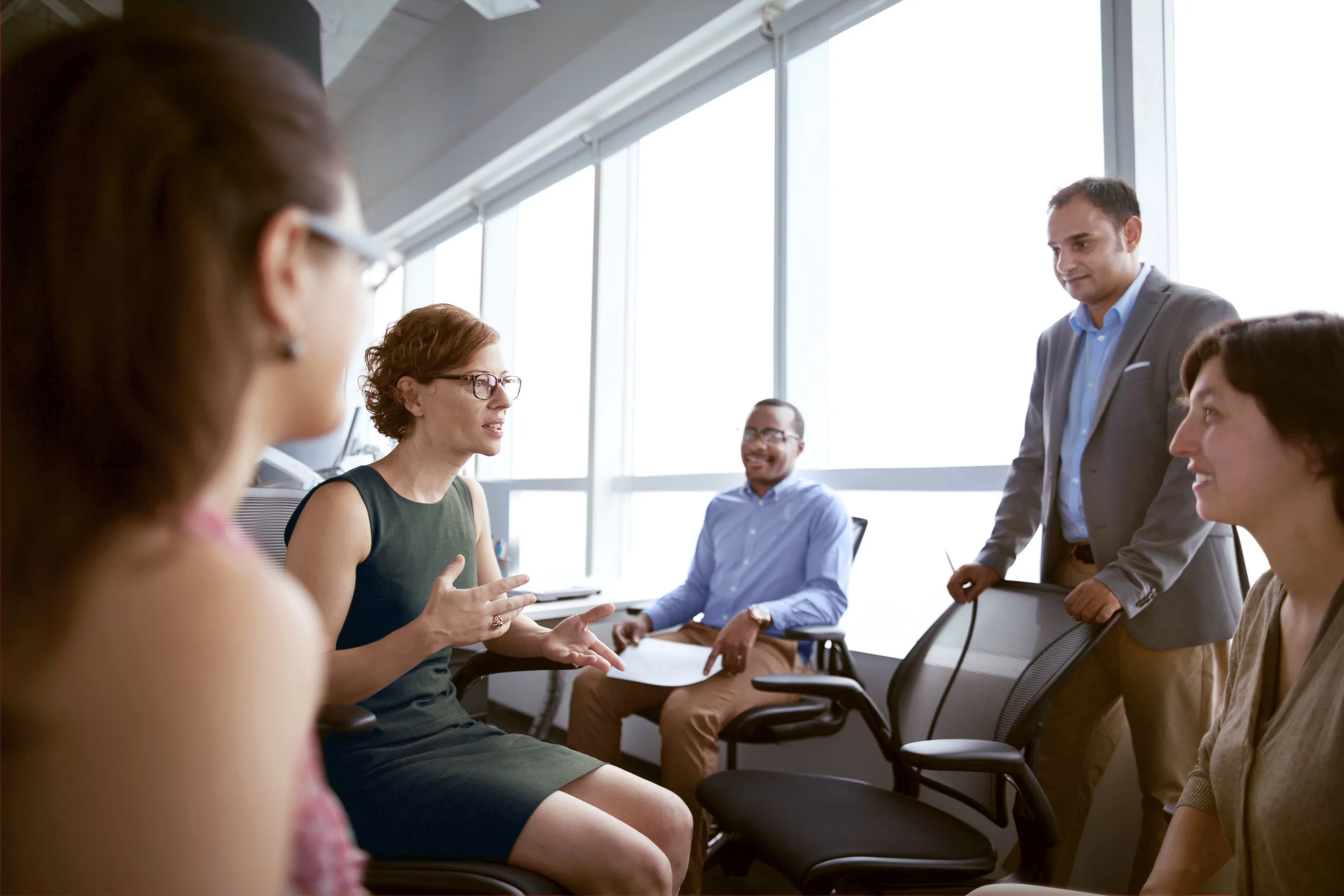 Mature-woman-talking-with-business-colleagues-in-office-637903914_5616x3744 (1).jpeg