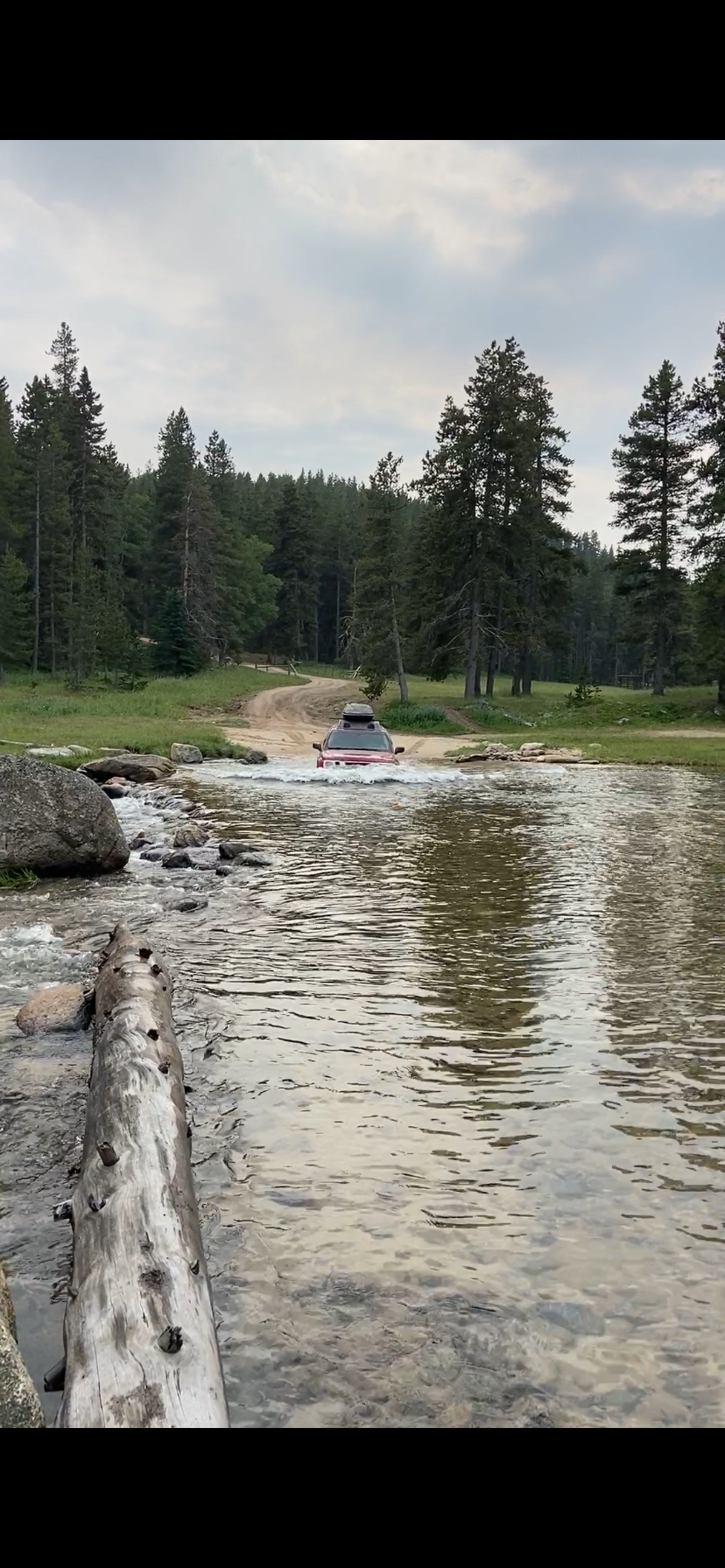 A vehicle crossing a stream in the Bighorn Mountains