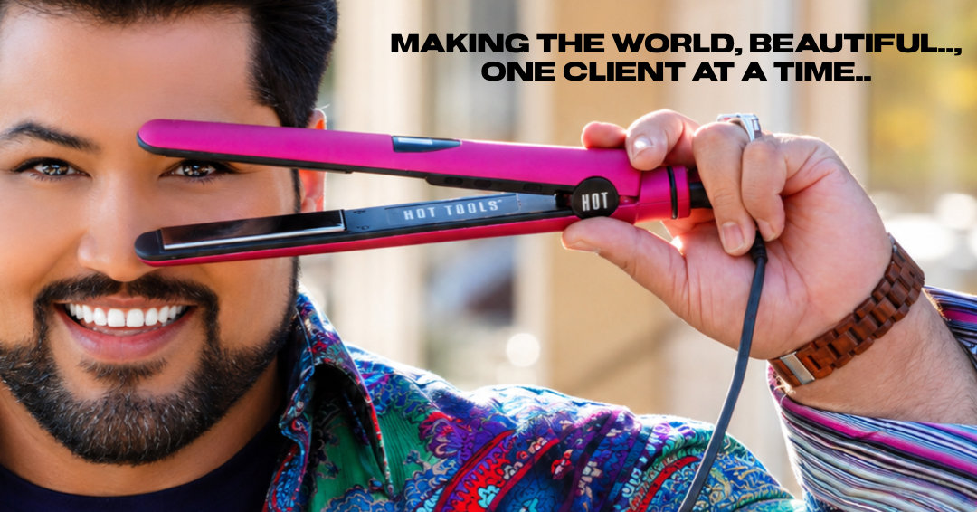 A man with a beard smiling and holding a pink hair straightener to his forehead, with the text 'Making the world, beautiful..., one client at a time...'