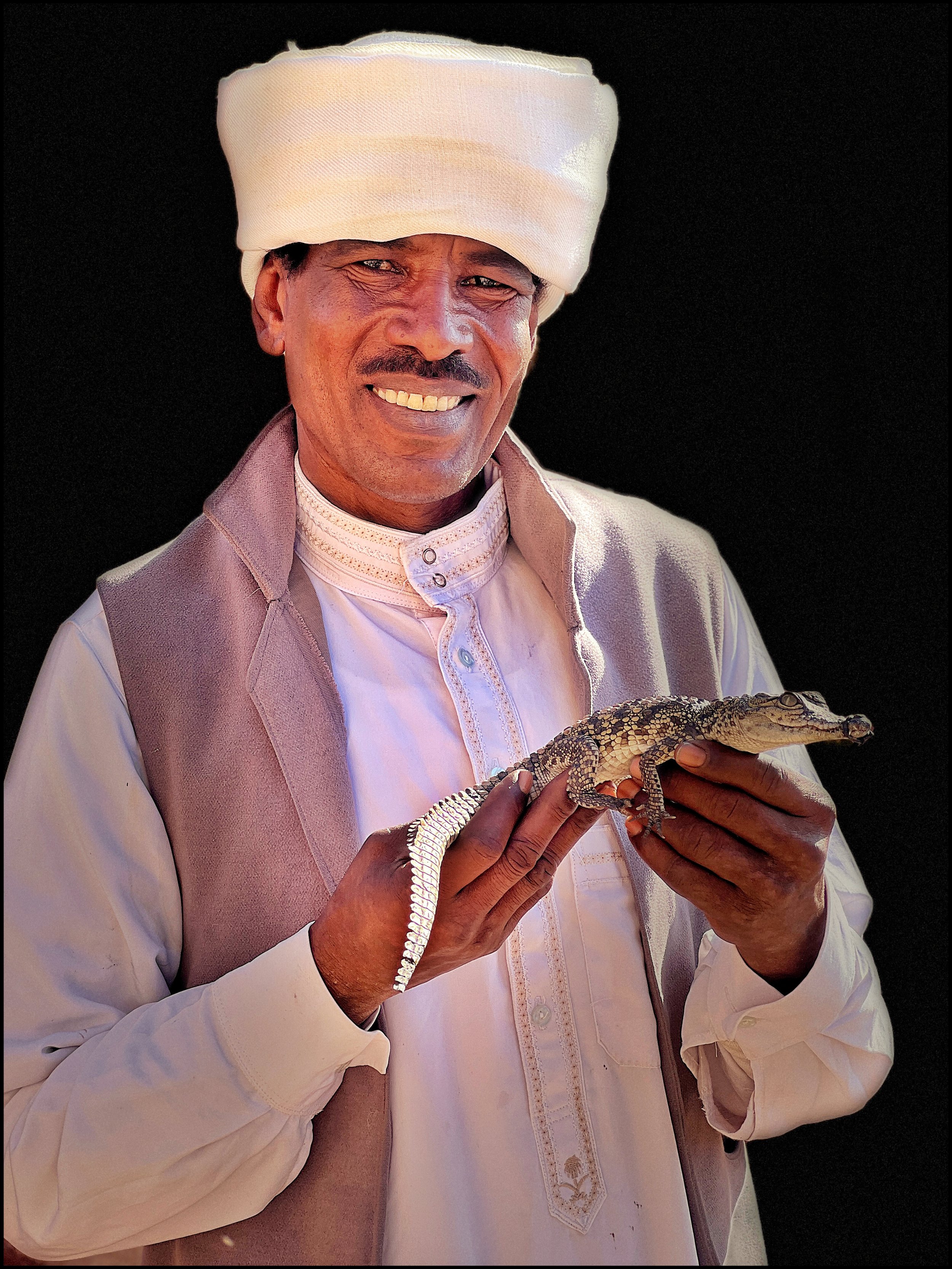  A temple attendant and his Nile crocodile. The ancient Egyptians honored the crocodile God Sobek. It’s a thin line between awful (awe-full) and awesome (awe-some).  — at New Wadi es-Sebua. 