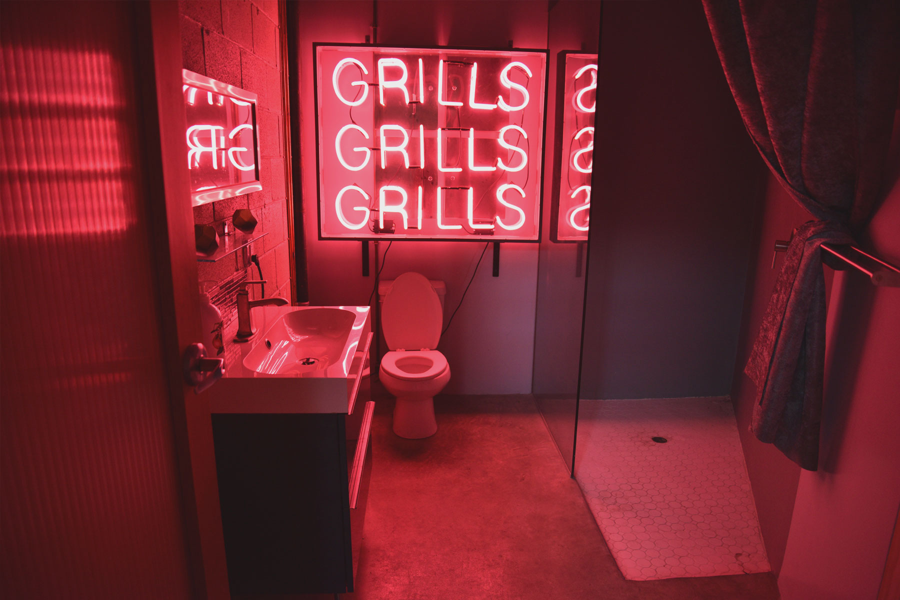 SocialSet - Bathroom with Neon Grills, Grills, Grills Sign