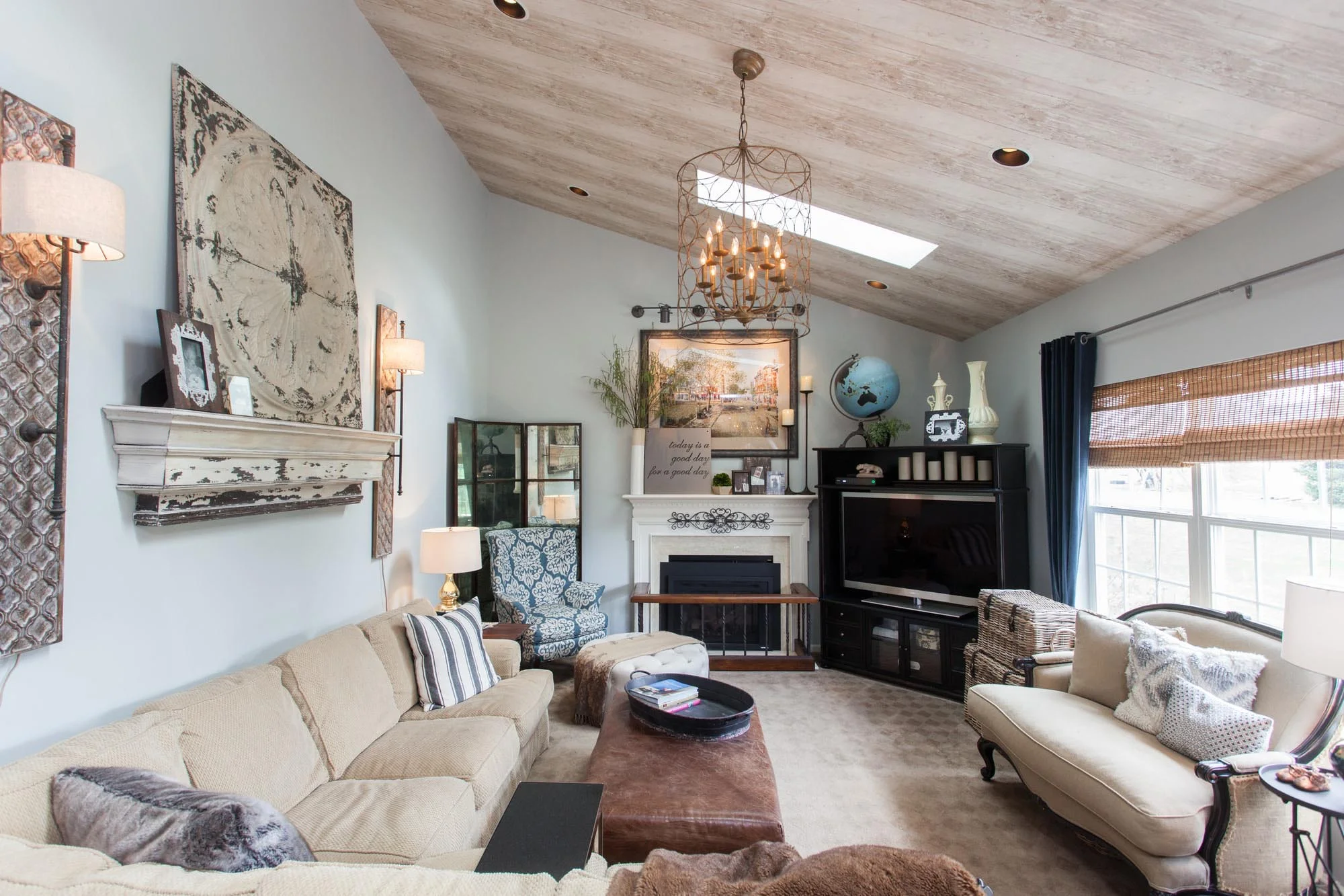 Bright sunroom with slanted ceiling, skylight and comfortable seating