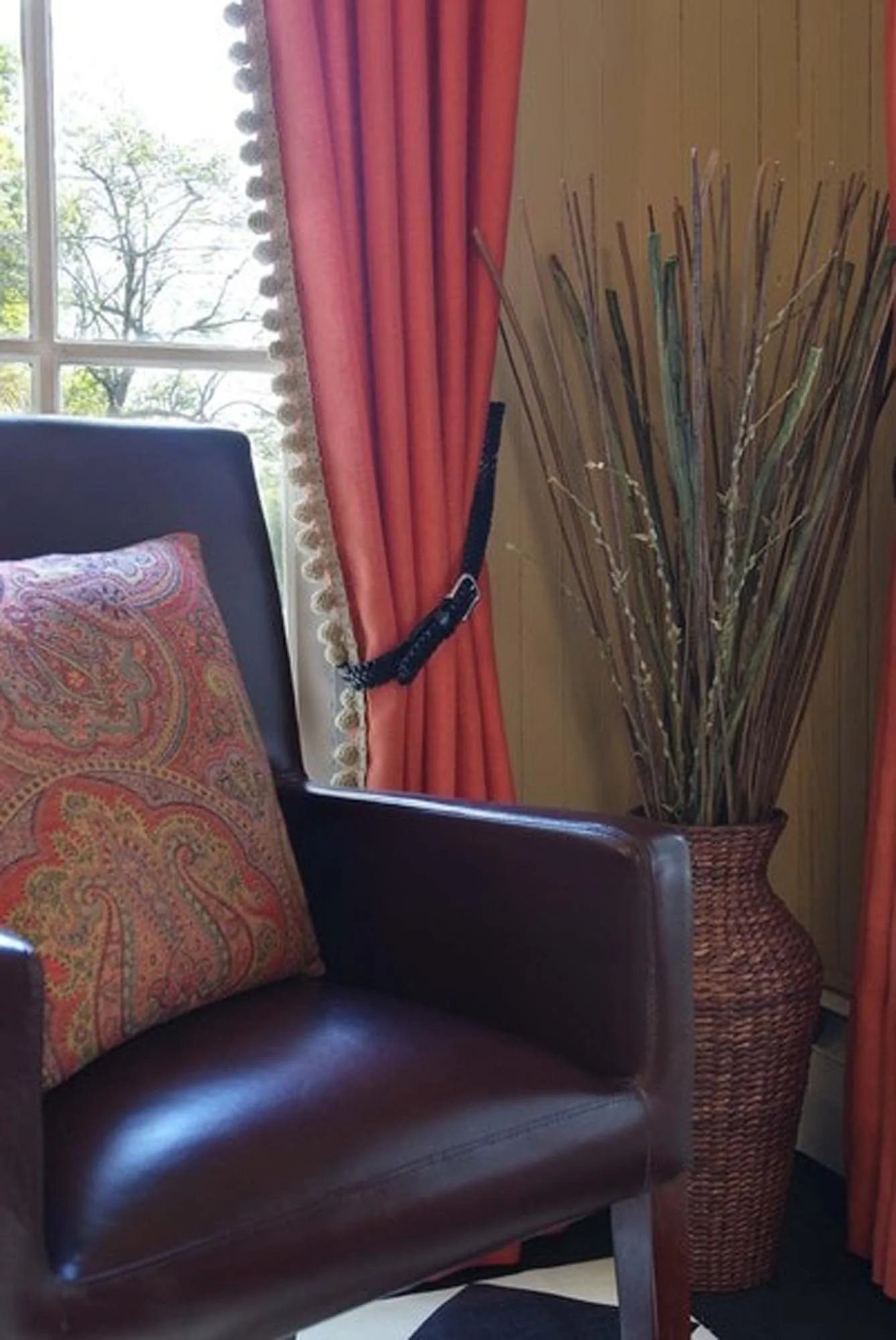 Brown leather chair in front of windows