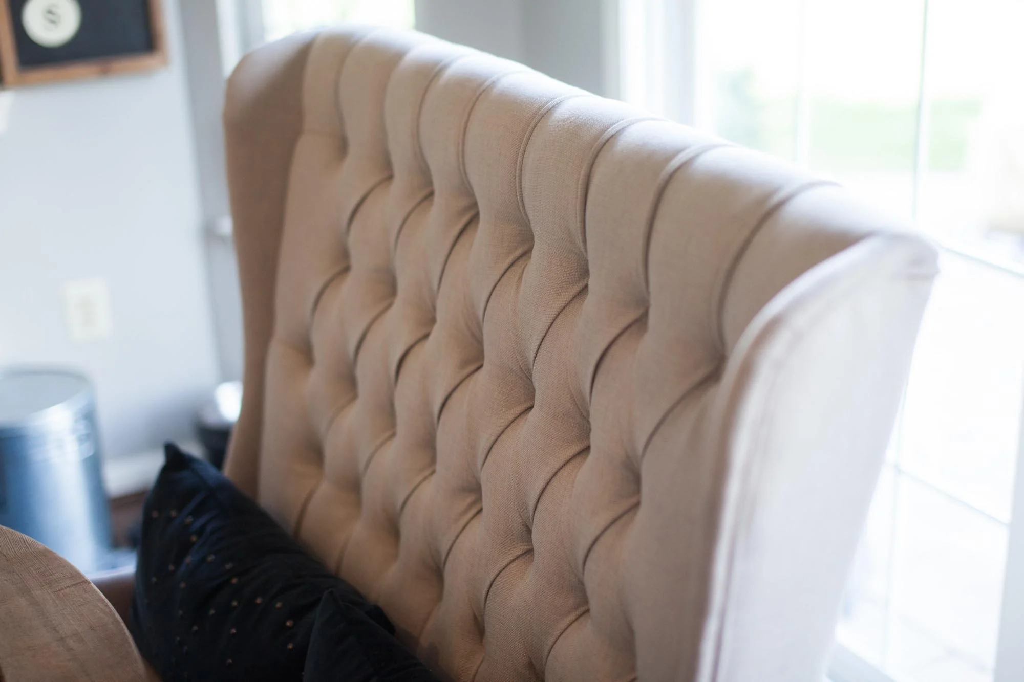 Beige colored stuffed chair with blue pillow