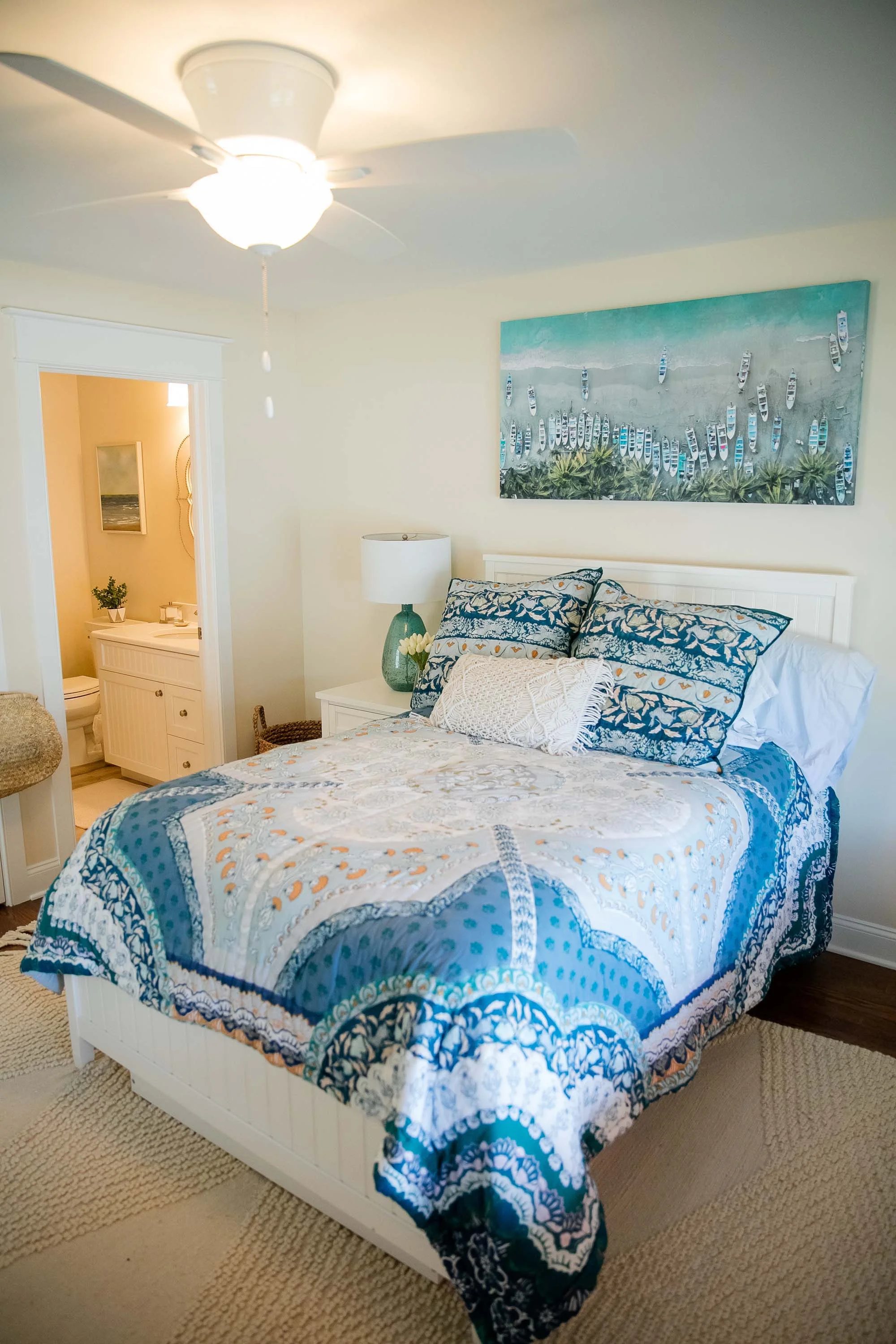 Double bed with bright blue and white bed covering