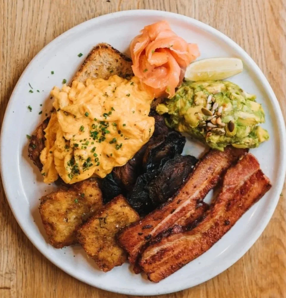 Big breakfast at Flight Coffee Hangar in Wellington with scrambled eggs, bacon, smoked salmon, avocado smash, hash browns, and mushrooms.
