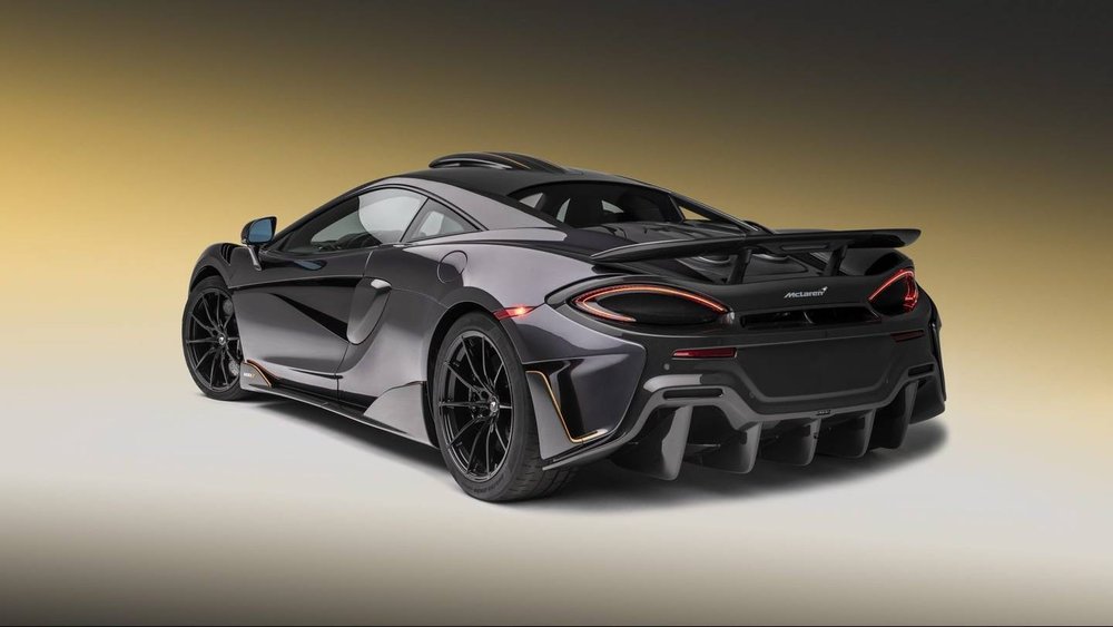 Dark grey McLaren 600LT supercar, seen from the rear three-quarter
