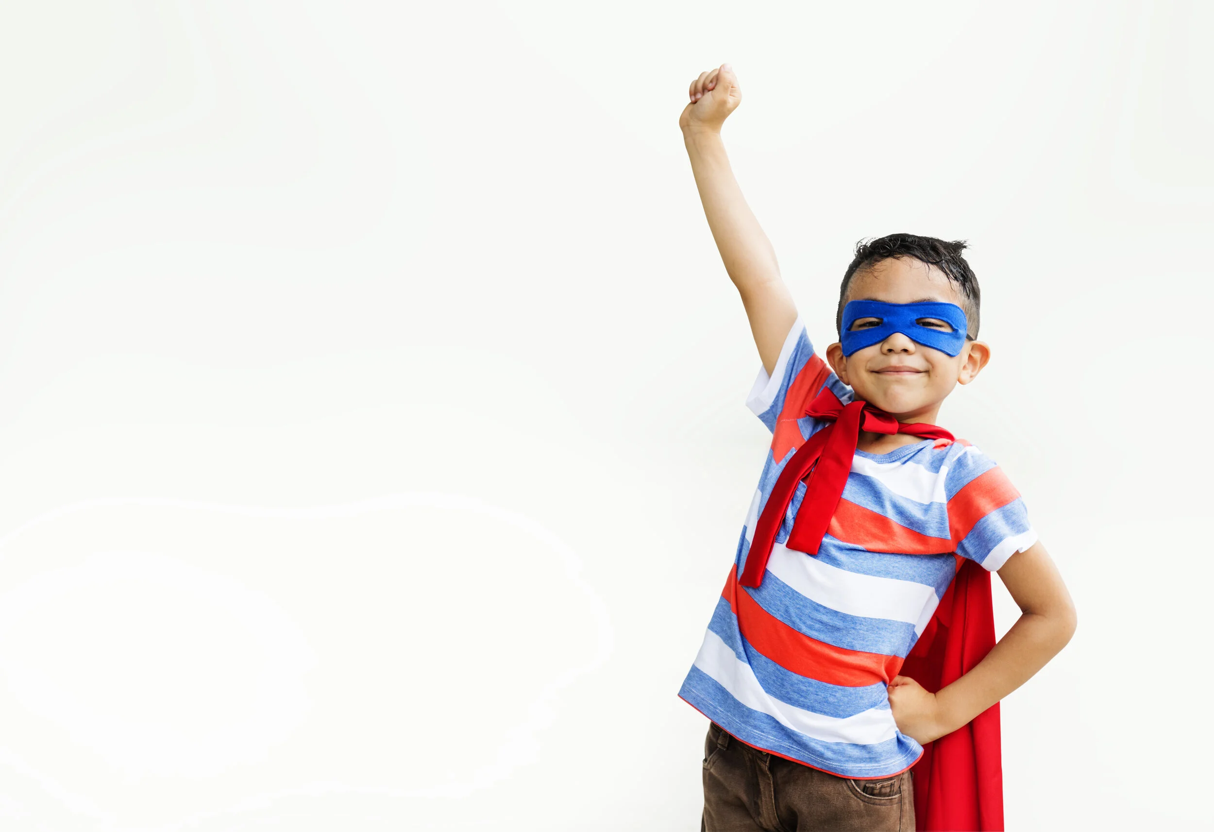  Little boy playing superhero at the playground 