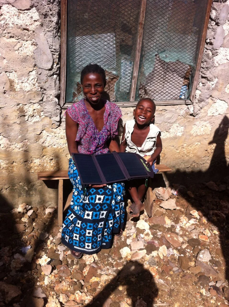 Mama Saidi with Simon and her solar panels